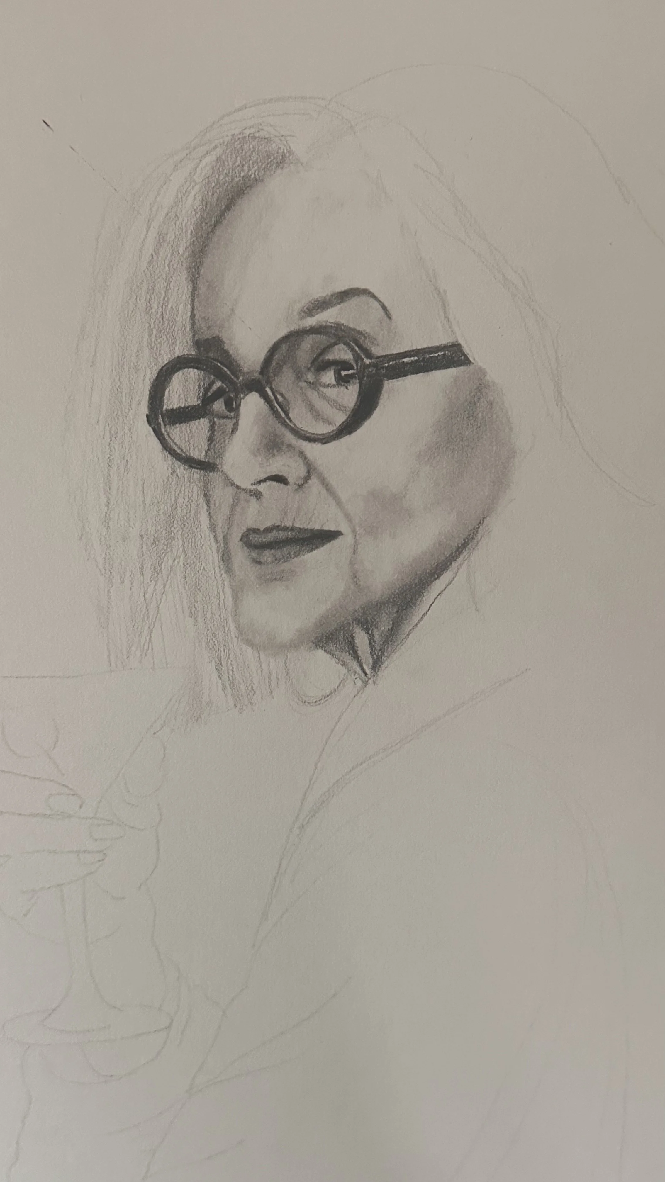 A detailed pencil sketch of a woman with glasses, partially finished, showing her face in profile with well-defined features and hair.