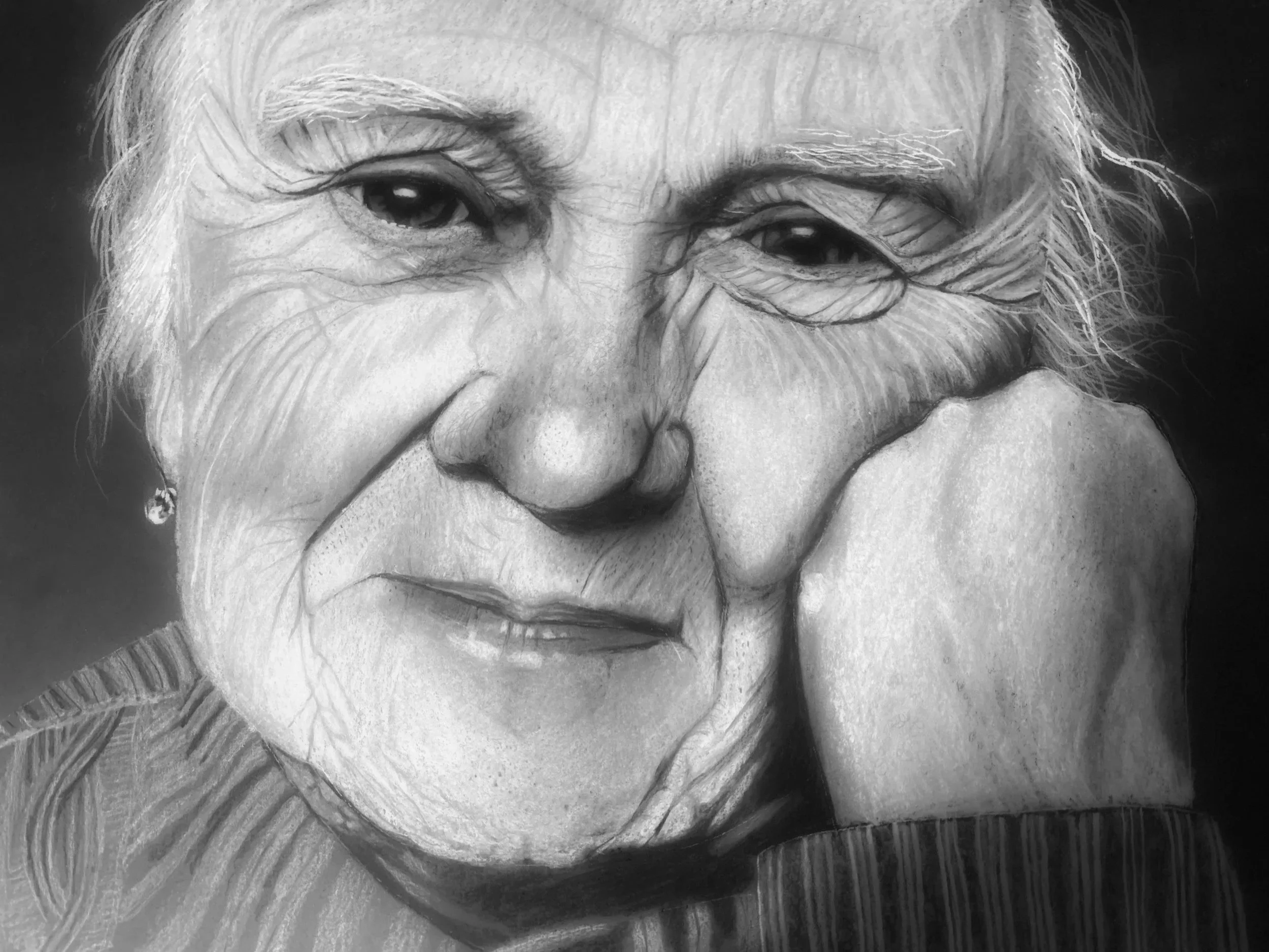 A detailed pencil sketch of an elderly woman's face, showing her eyes, nose, and mouth.