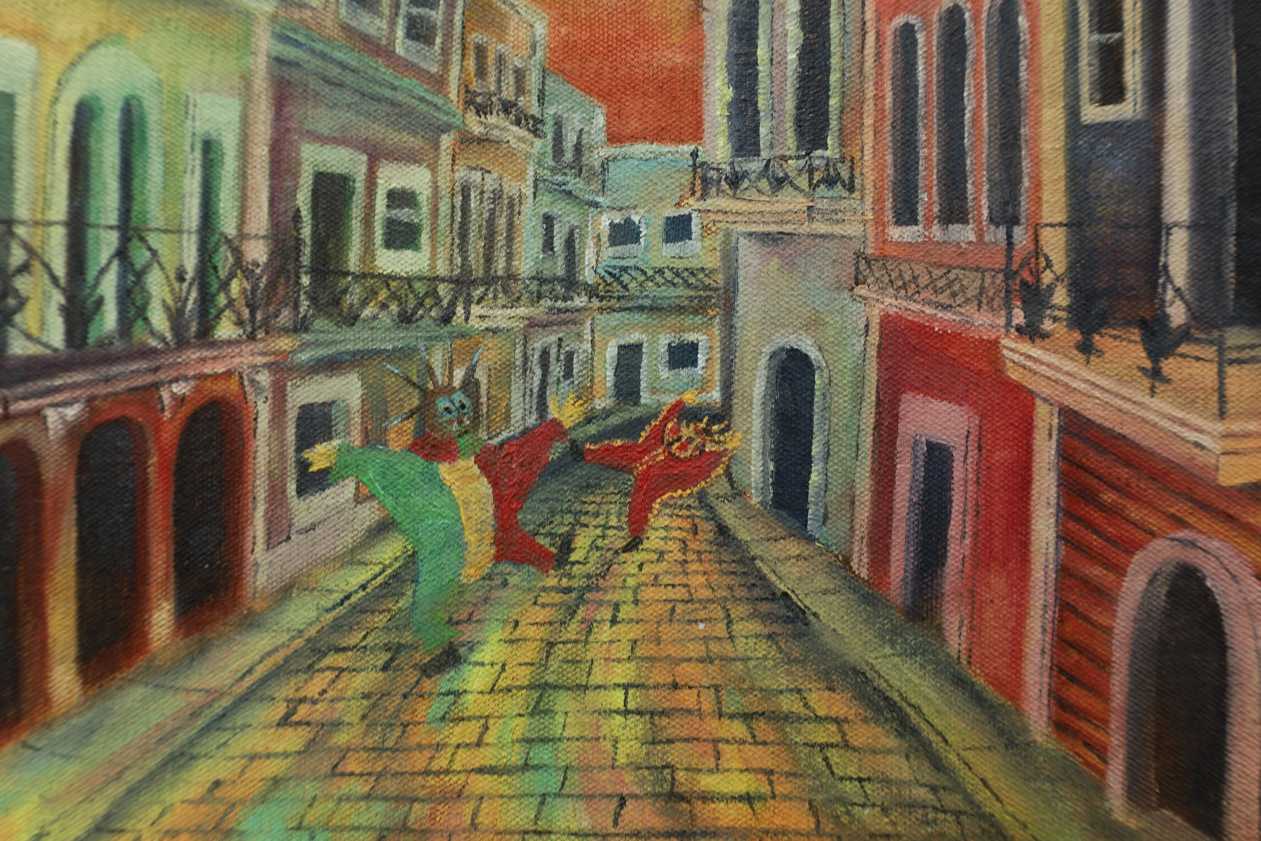 Painting of a colorful Puerto rican street scene with buildings, balconies, and a cobblestone street, featuring vejiegante dancing in the foreground. 