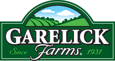 Logo for Garelick Farms featuring a green and white color scheme with a mountain landscape and a spring/cloud scene, including the text 'Garelick Farms Since 1931'