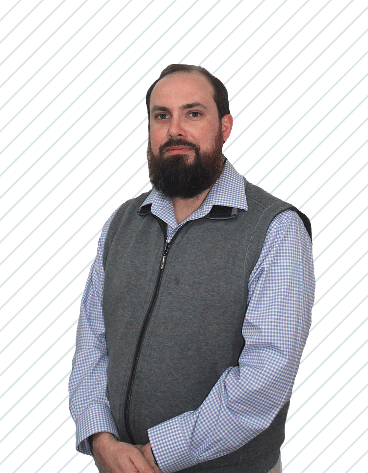 Man with a beard wearing a gray vest over a blue checkered shirt, owner and founder of Bay Wellness Group Jonathan Rollins.