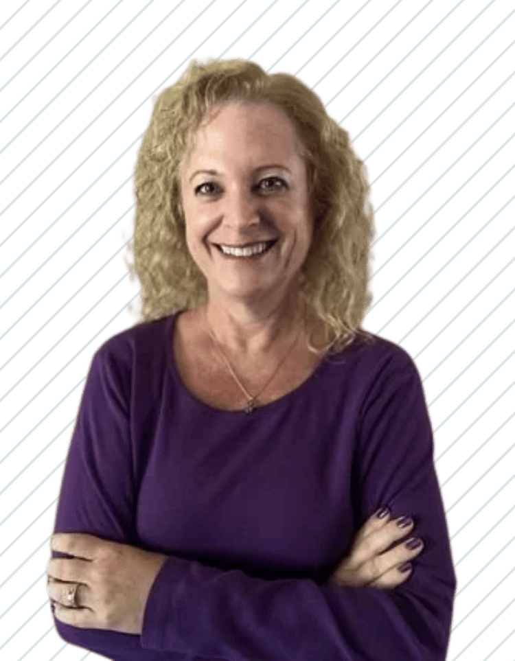 A woman with curly blonde hair smiling and crossing her arms, wearing a purple top, Debbie Huffman of Bay Wellness Group.