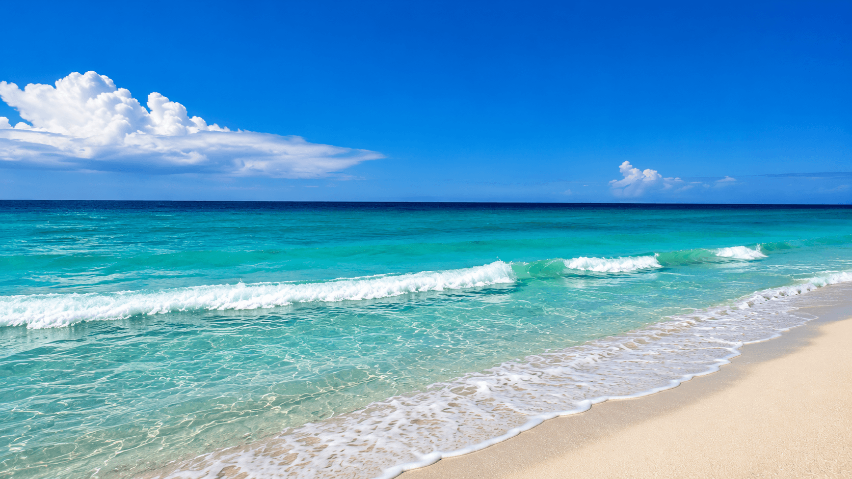 Clear blue sky with some clouds over a calm turquoise ocean with gentle waves, sandy beach in the foreground, Panama City Beach, Florida.