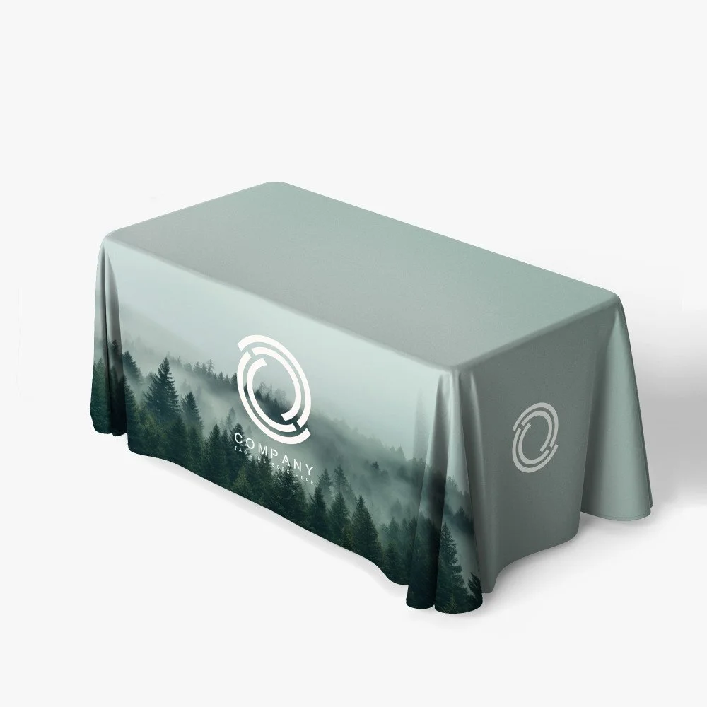 Tablecloth with a forest landscape design and a company logo.