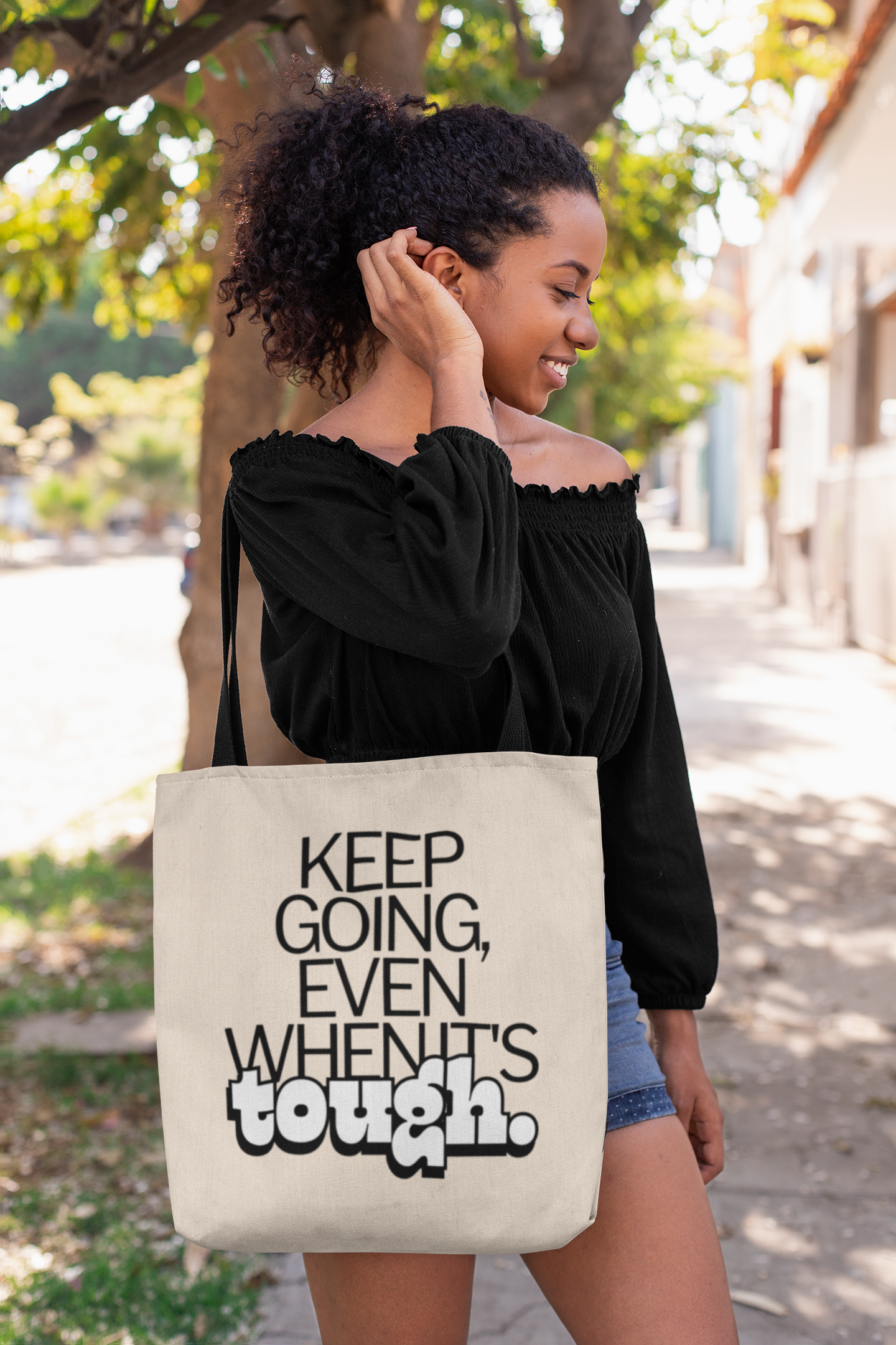 tote-bag-mockup-of-a-woman-fixing-her-hair-on-a-street-26695 (1).png