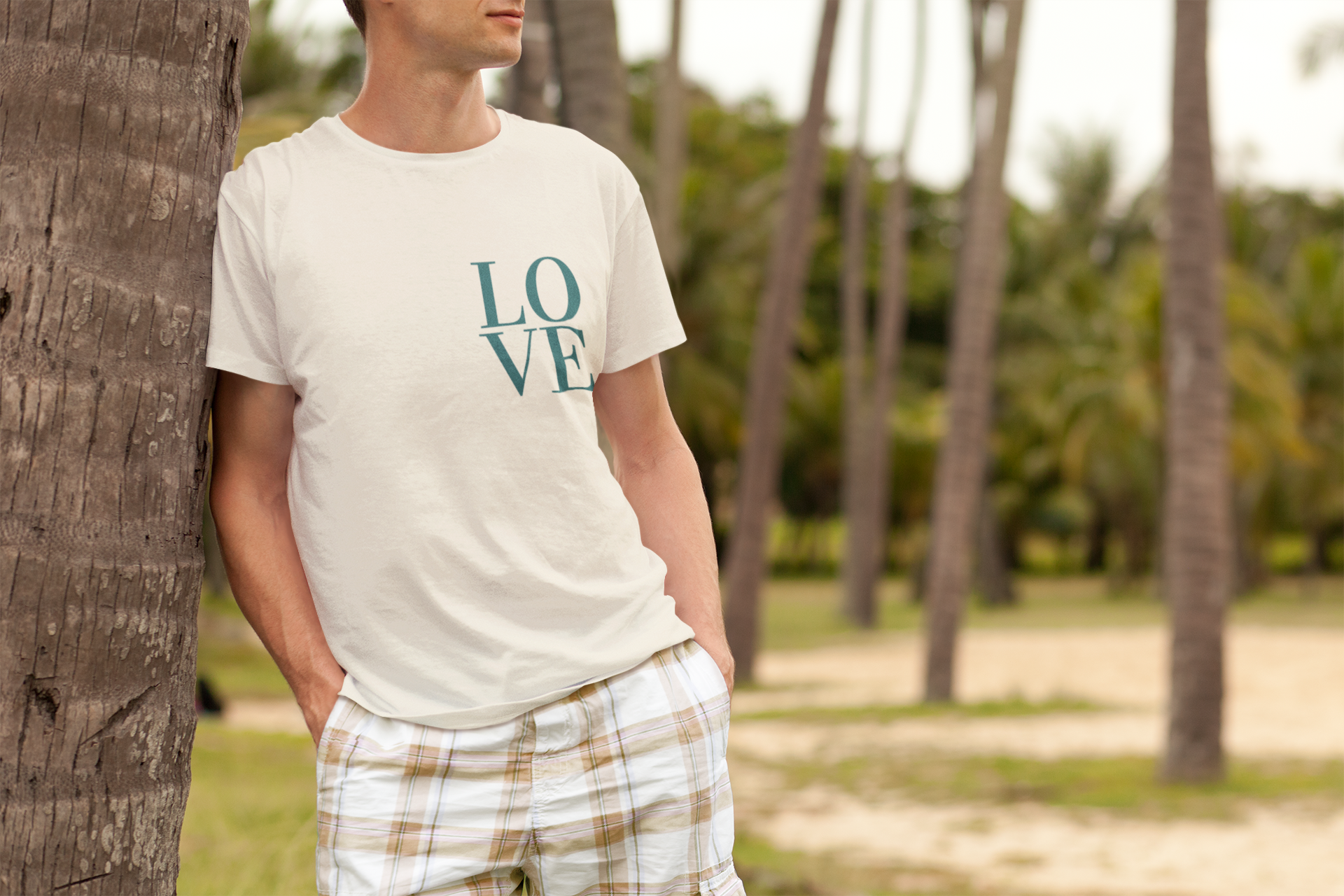 t-shirt-mockup-featuring-a-man-leaning-on-a-palm-tree-2753-el1.png