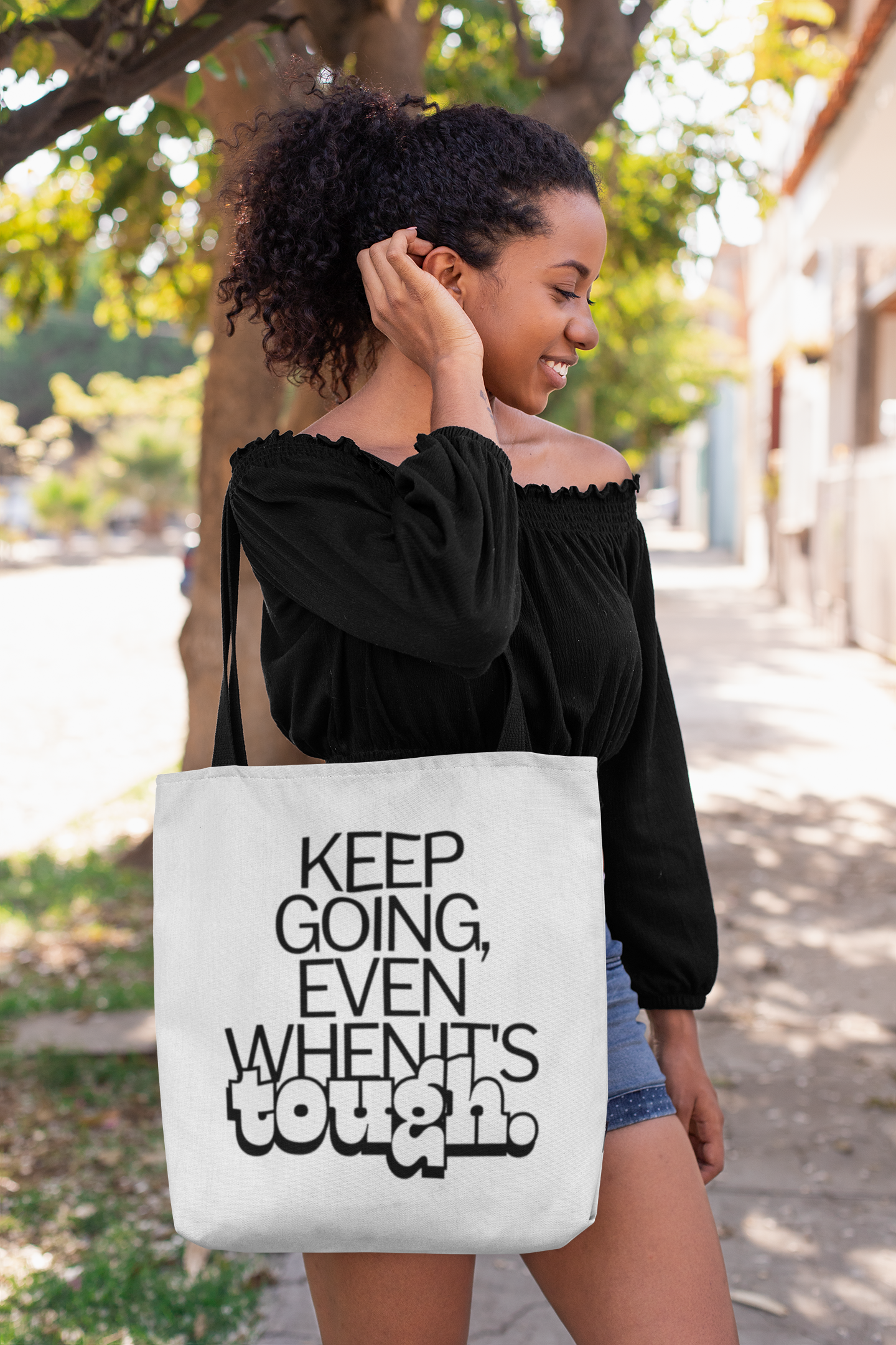 tote-bag-mockup-of-a-woman-fixing-her-hair-on-a-street-26695.png