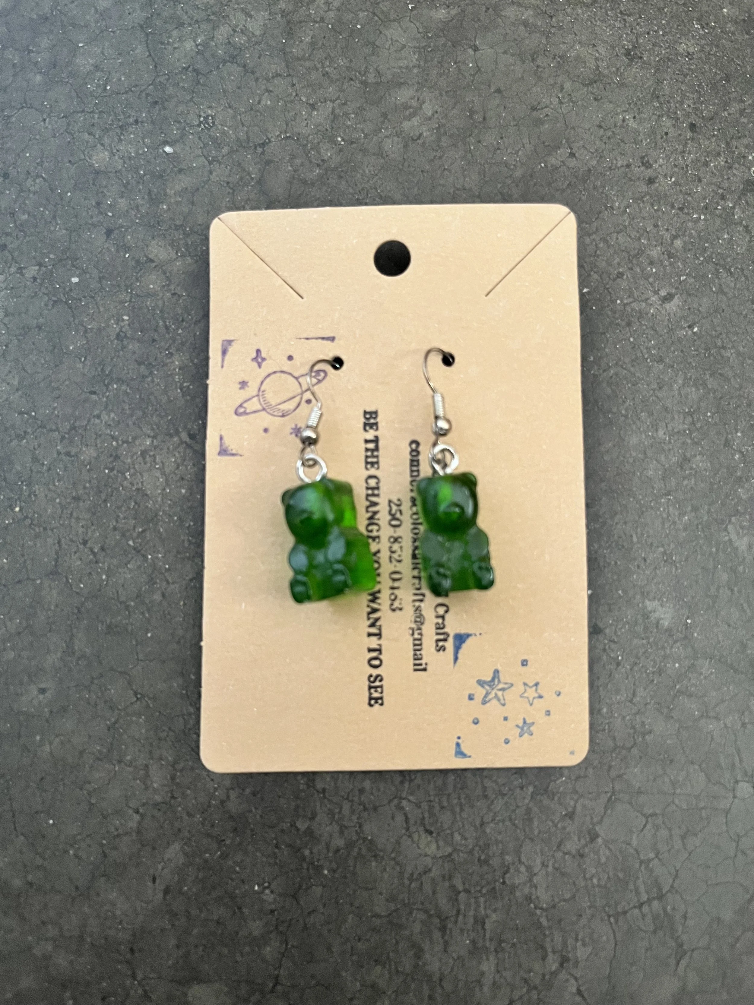 Green gummy bear earrings that are handmade.