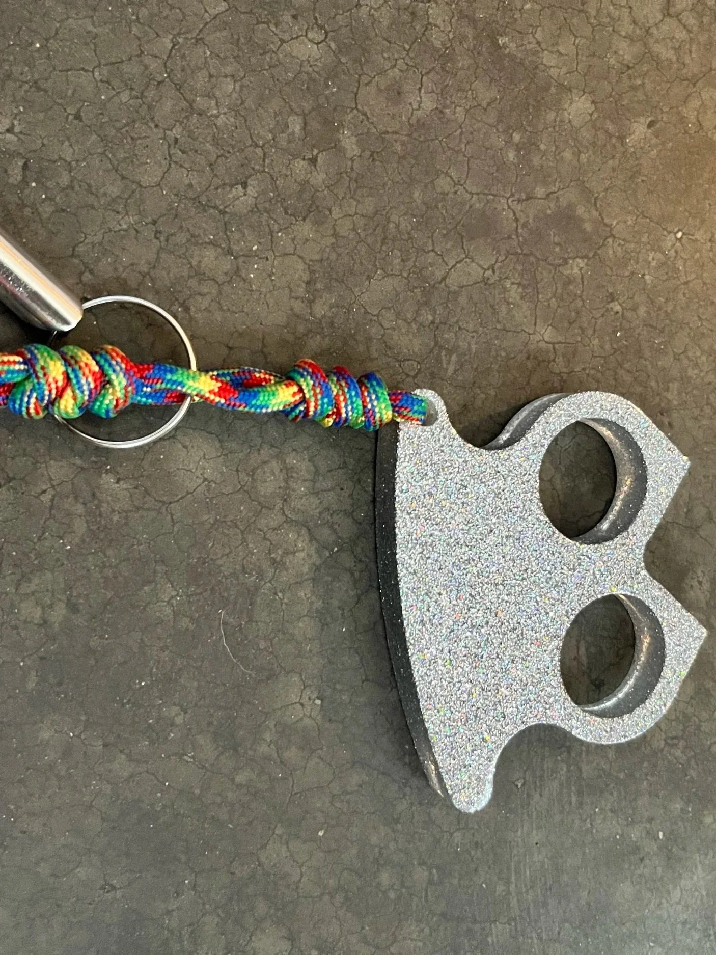 A handmade sliver paracord resin epoxy emergency keychain.