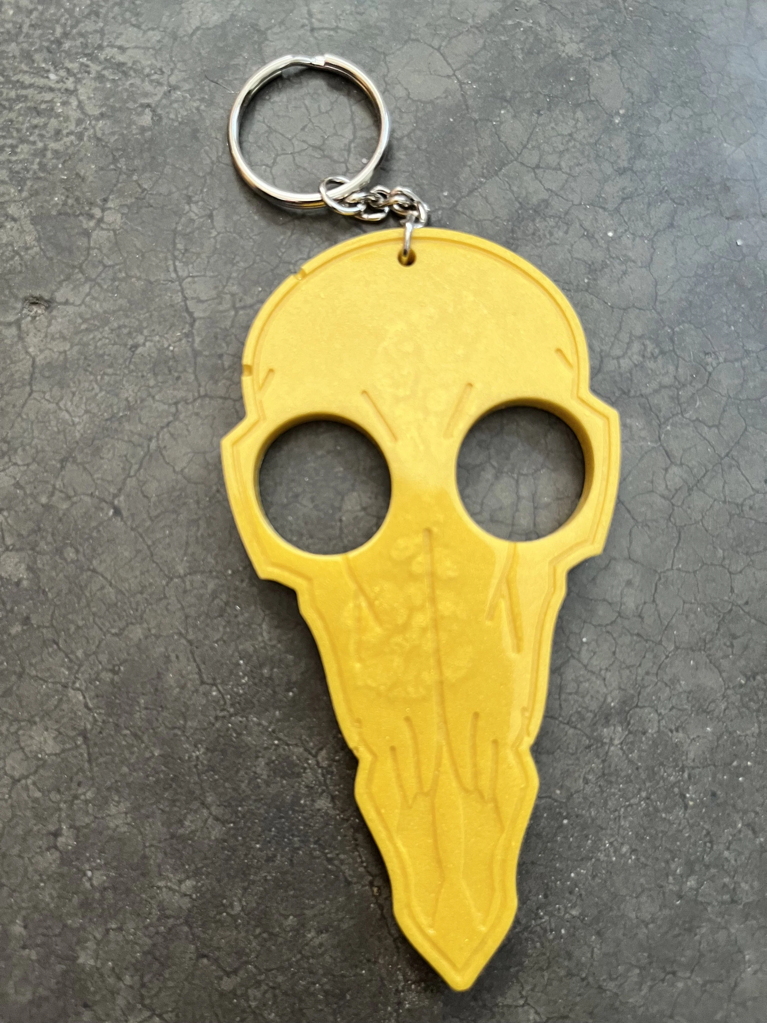 Yellow bird skull emergency keychain made from epoxy resin.