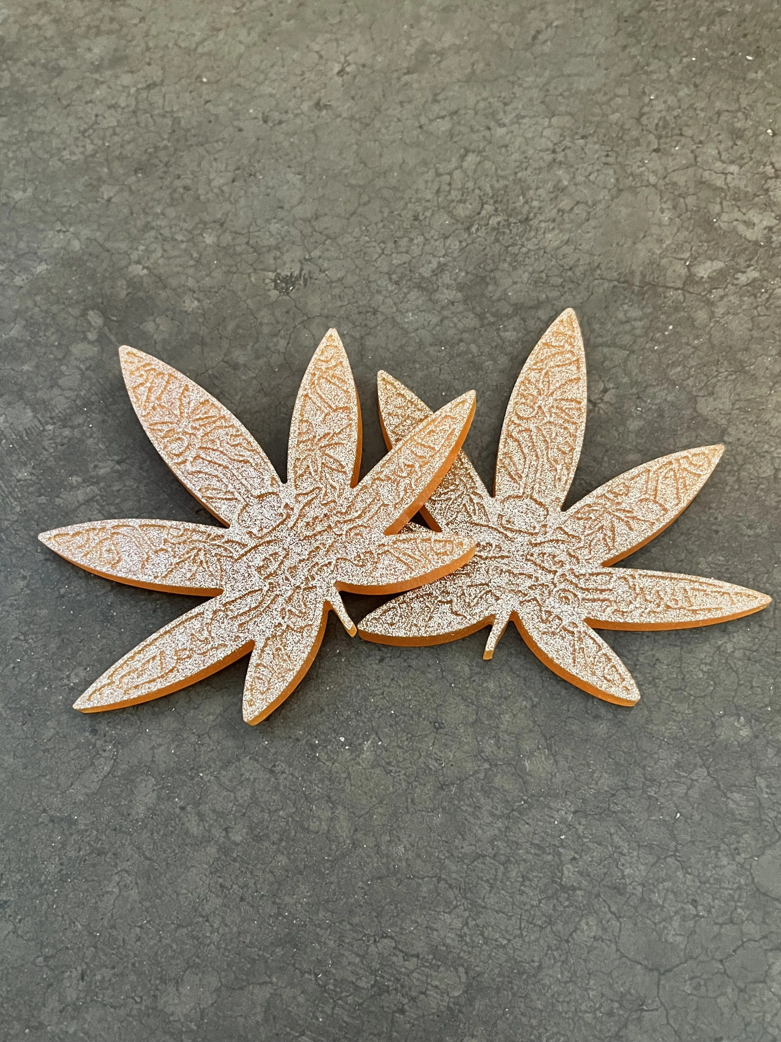 Two orange marijuana coasters.