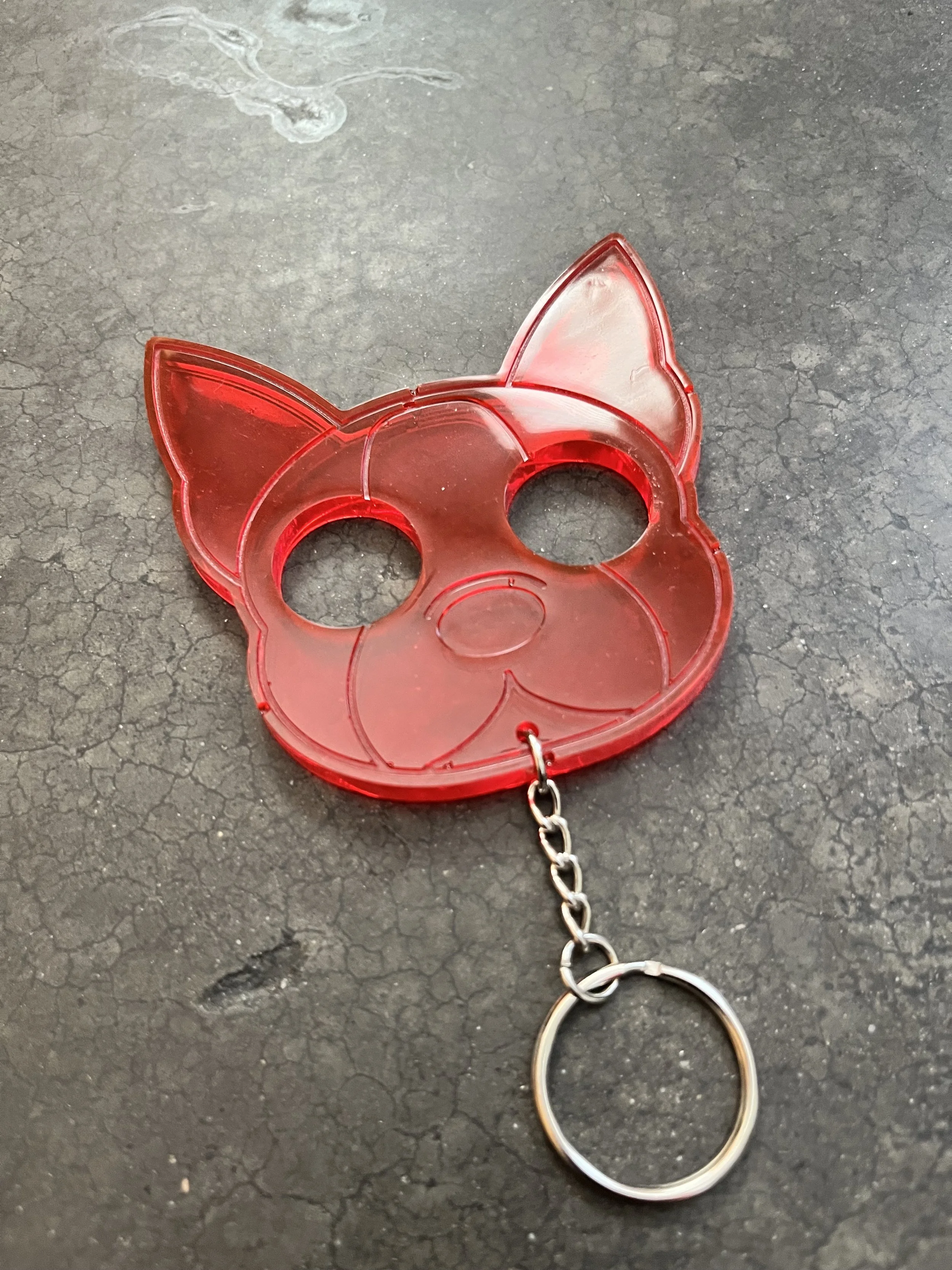 A handmade red resin epoxy emergency keychain.