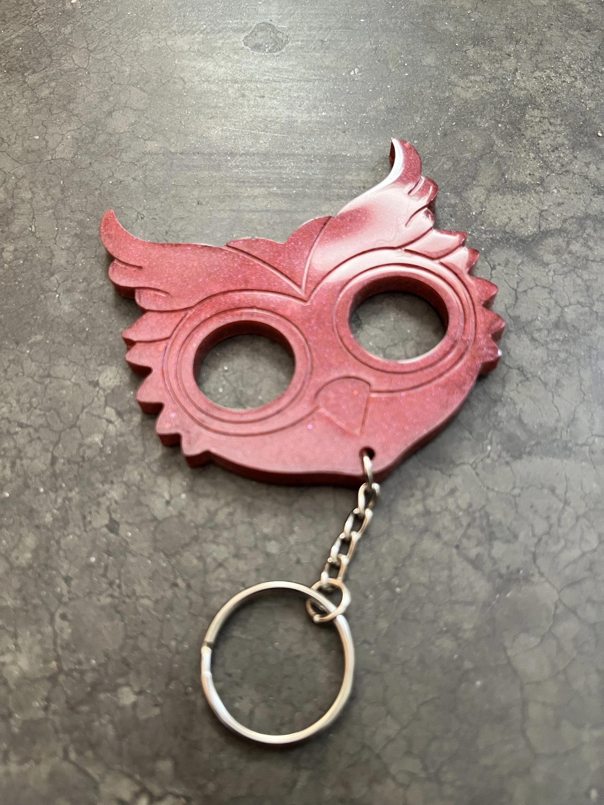 A handmade red owl resin epoxy emergency keychain.