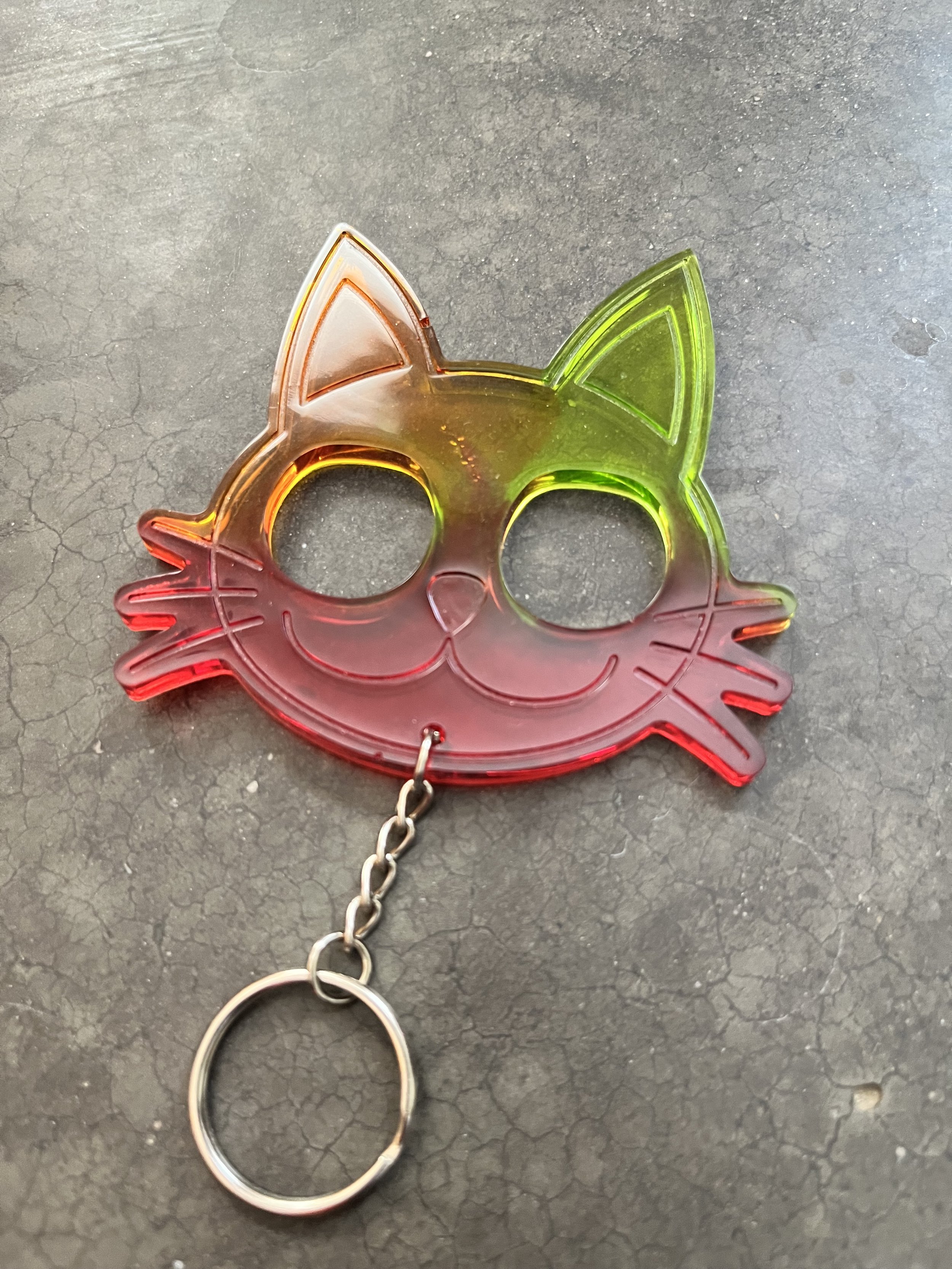 A colorful cat face emergency keychain made from epoxy resin.