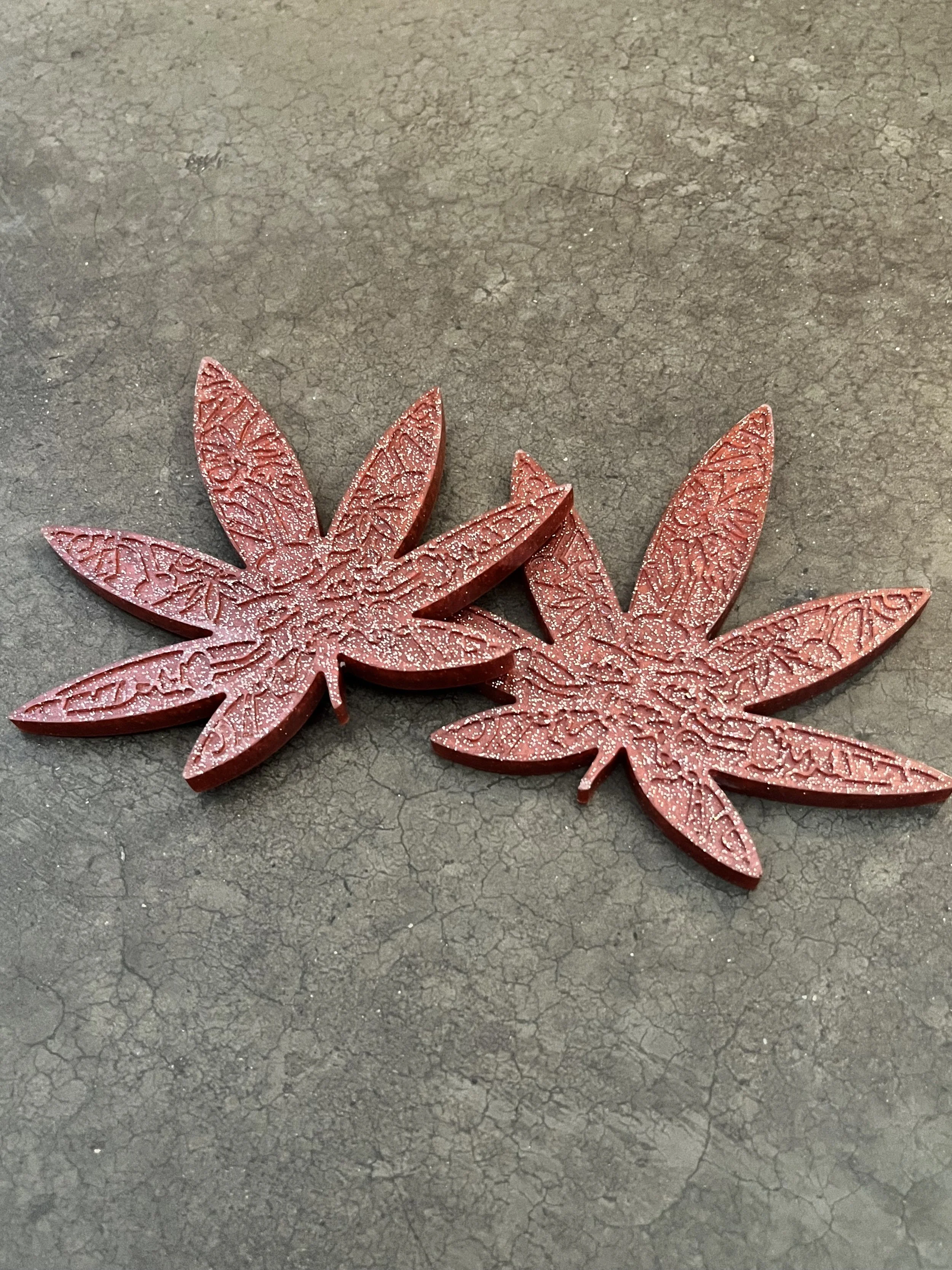 Handmade red marijuana leaf coasters.