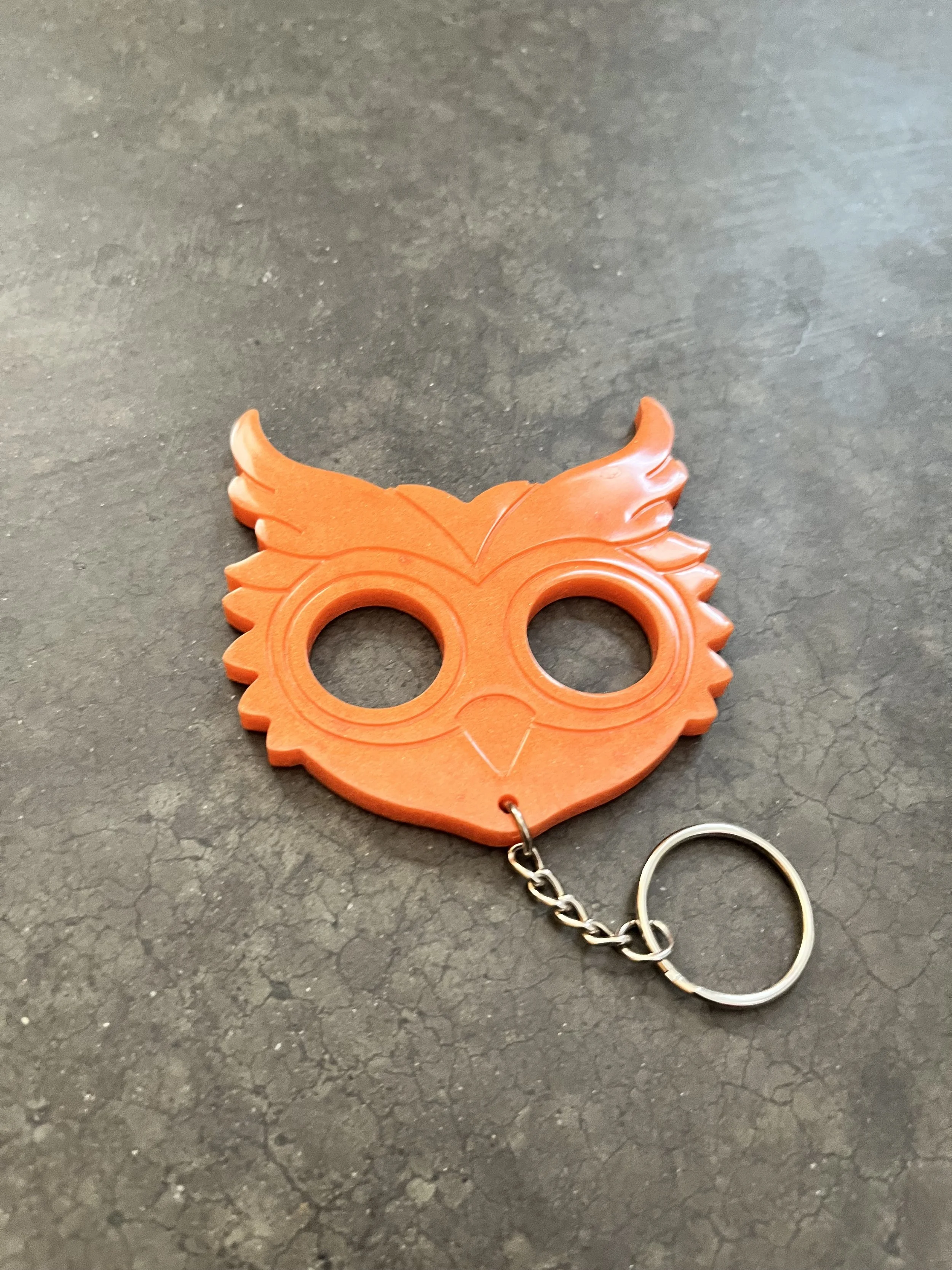 Orange plastic owl emergency keychain made from epoxy resin.