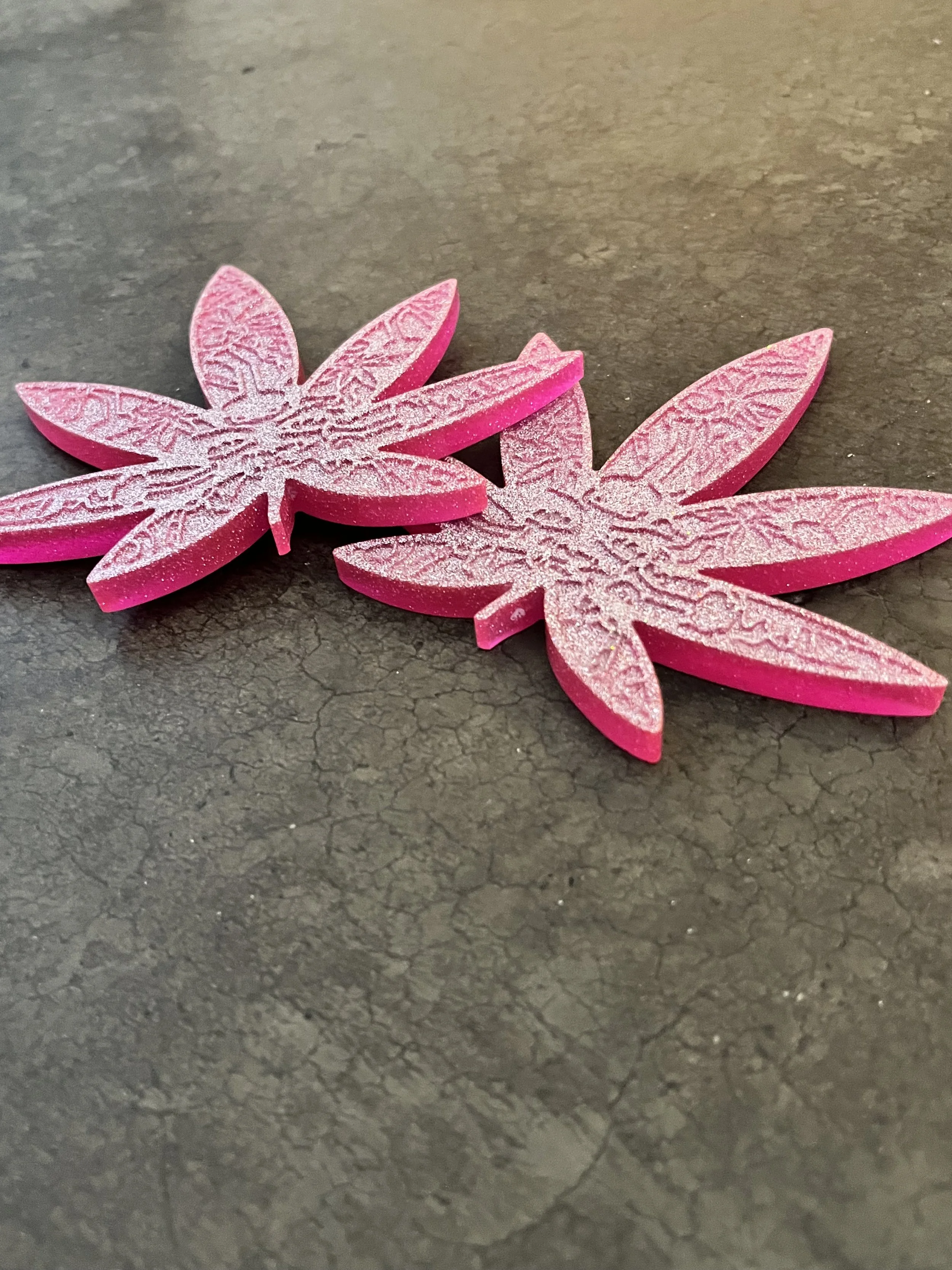 Handmade pink marijuana leaf coasters made from resin epoxy.