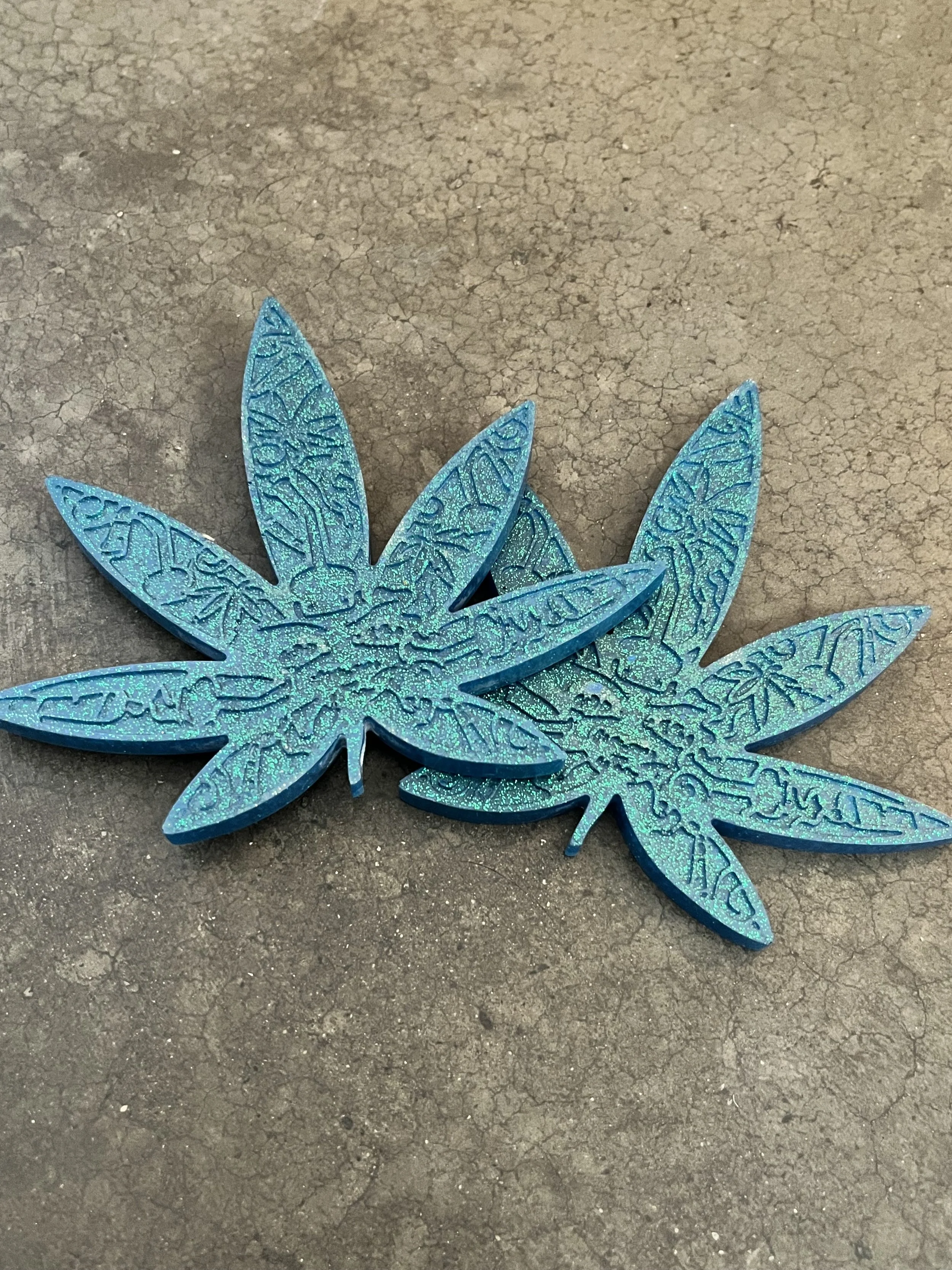 Handmade blue metallic marijuana leaf coasters.