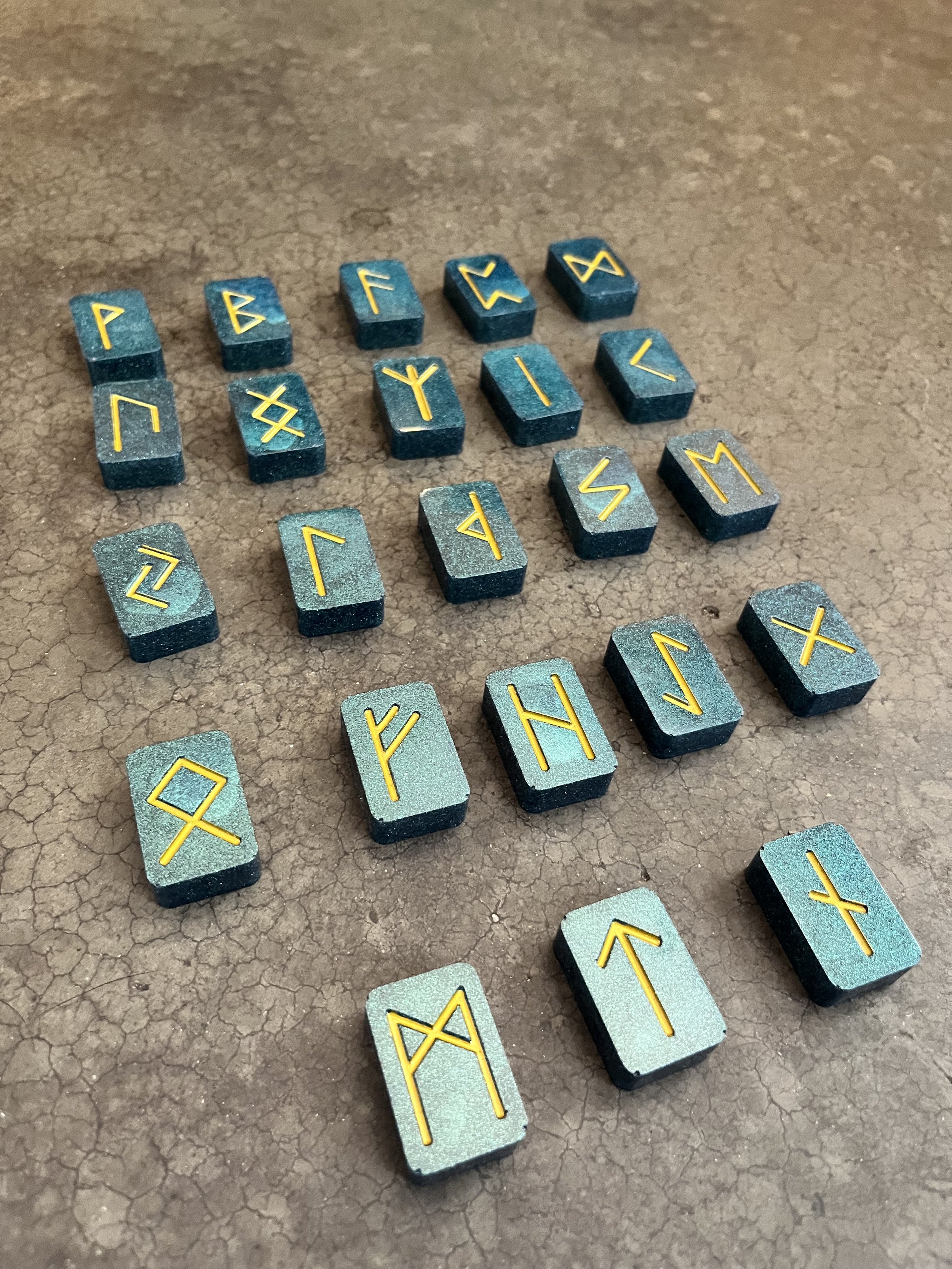 Handmade blue and gold rune stones.