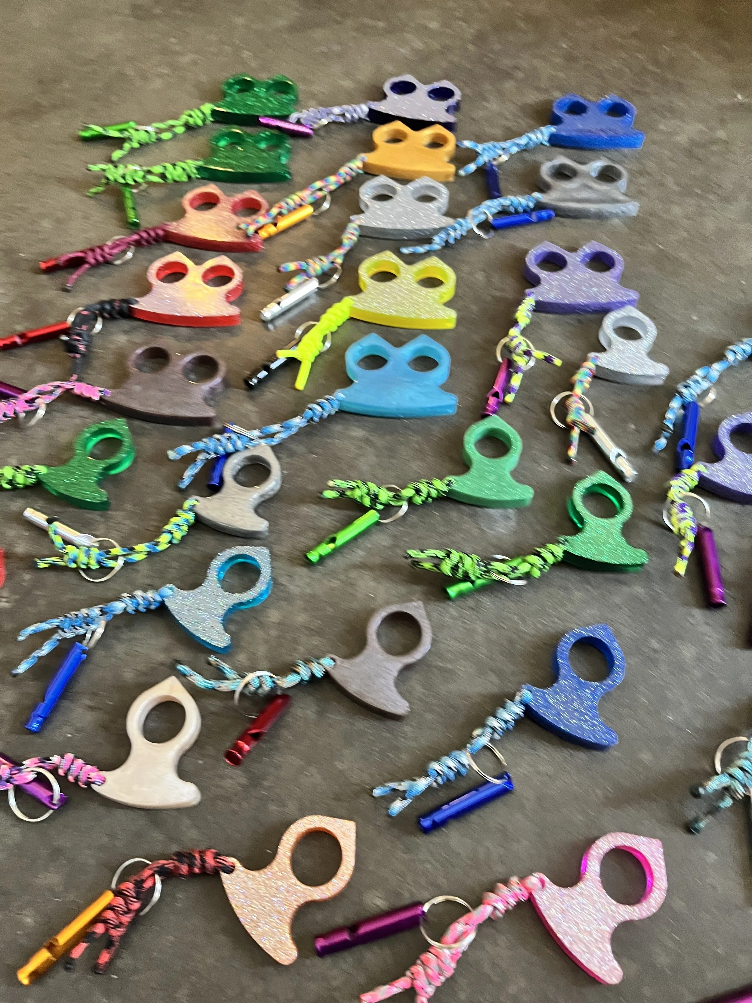 A handmade collection of colorful resin epoxy emergency keychains.