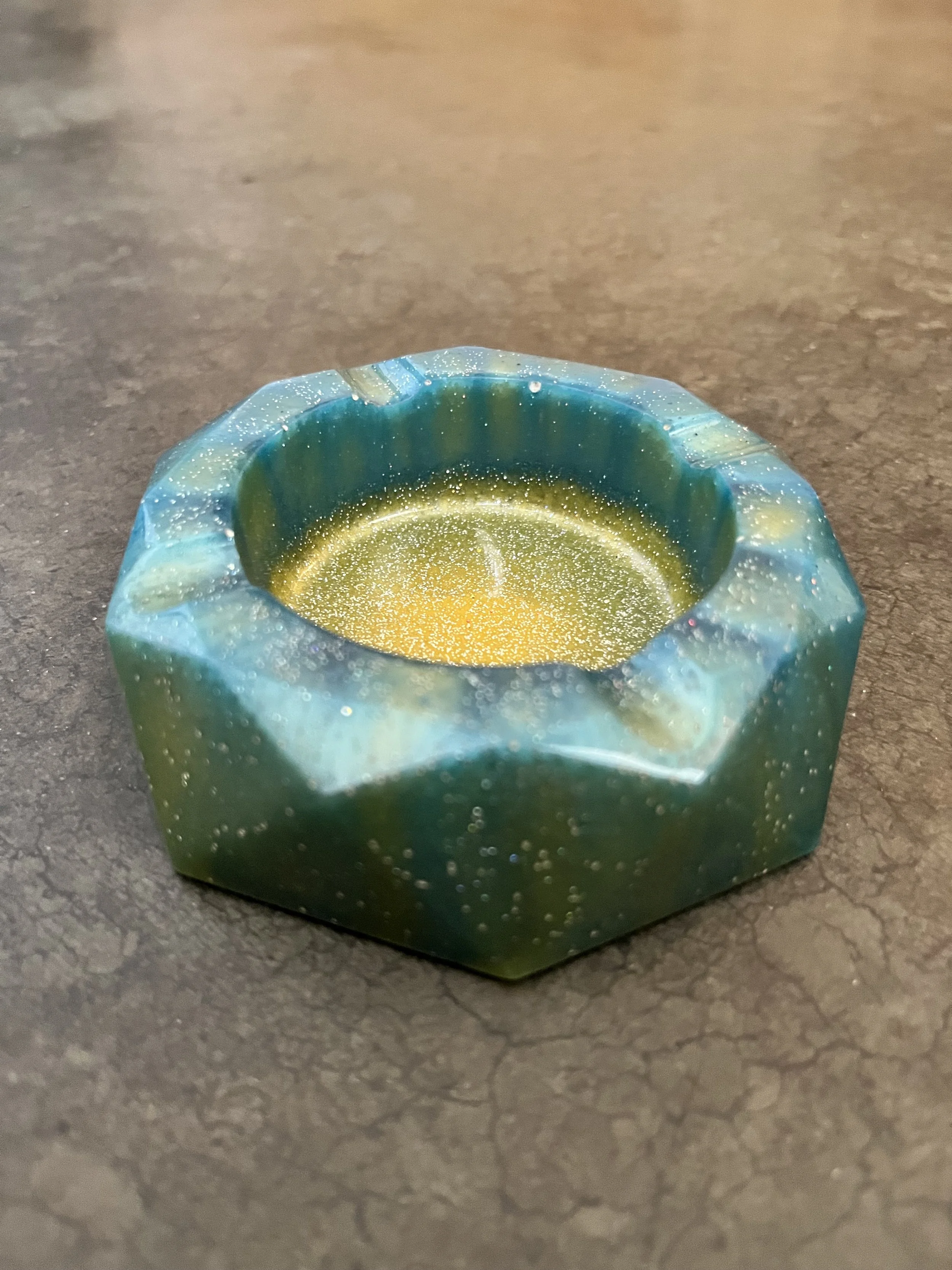 A multicolored, shimmering ash tray.