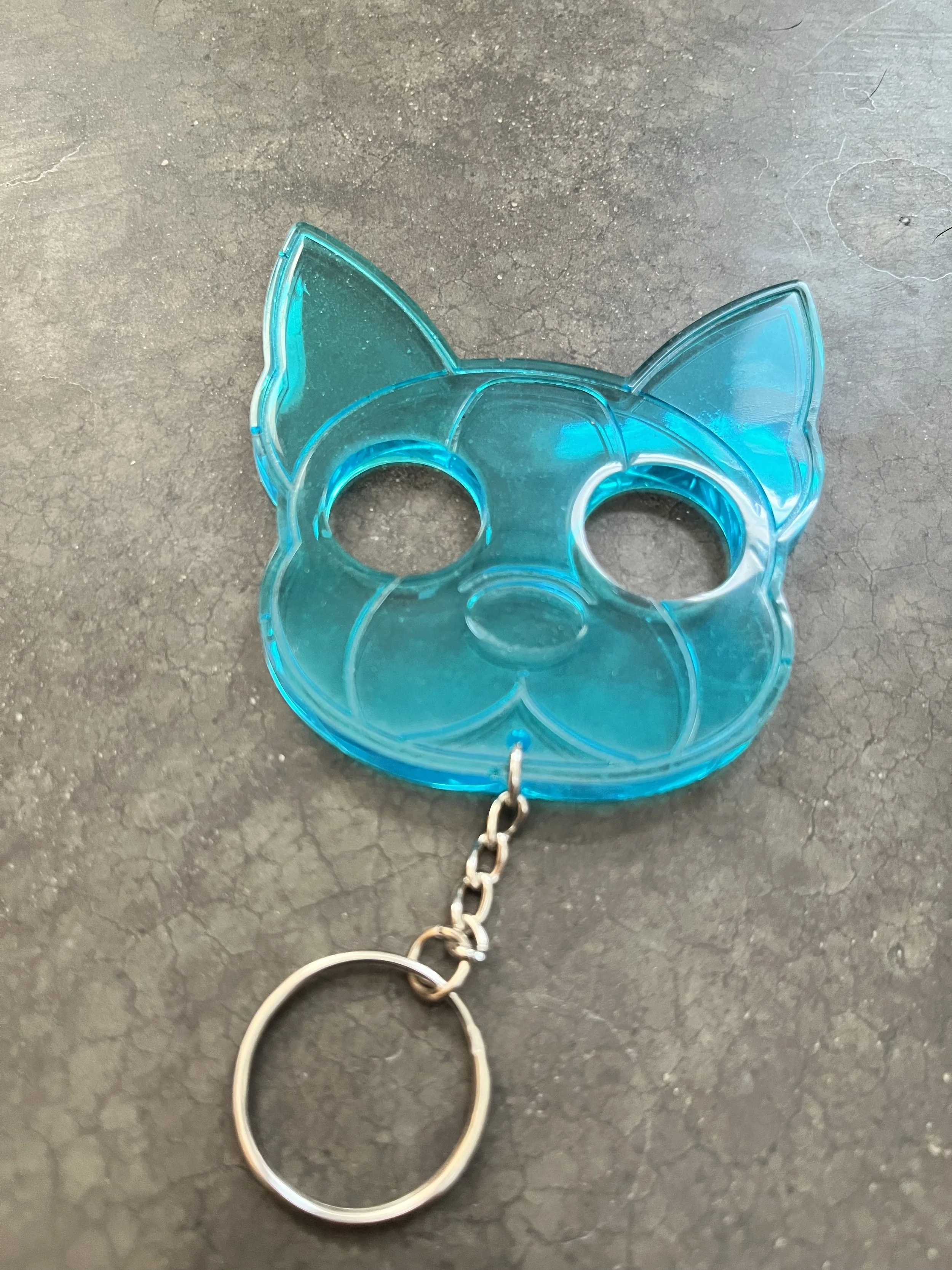 A blue emergency keychain made from epoxy resin.
