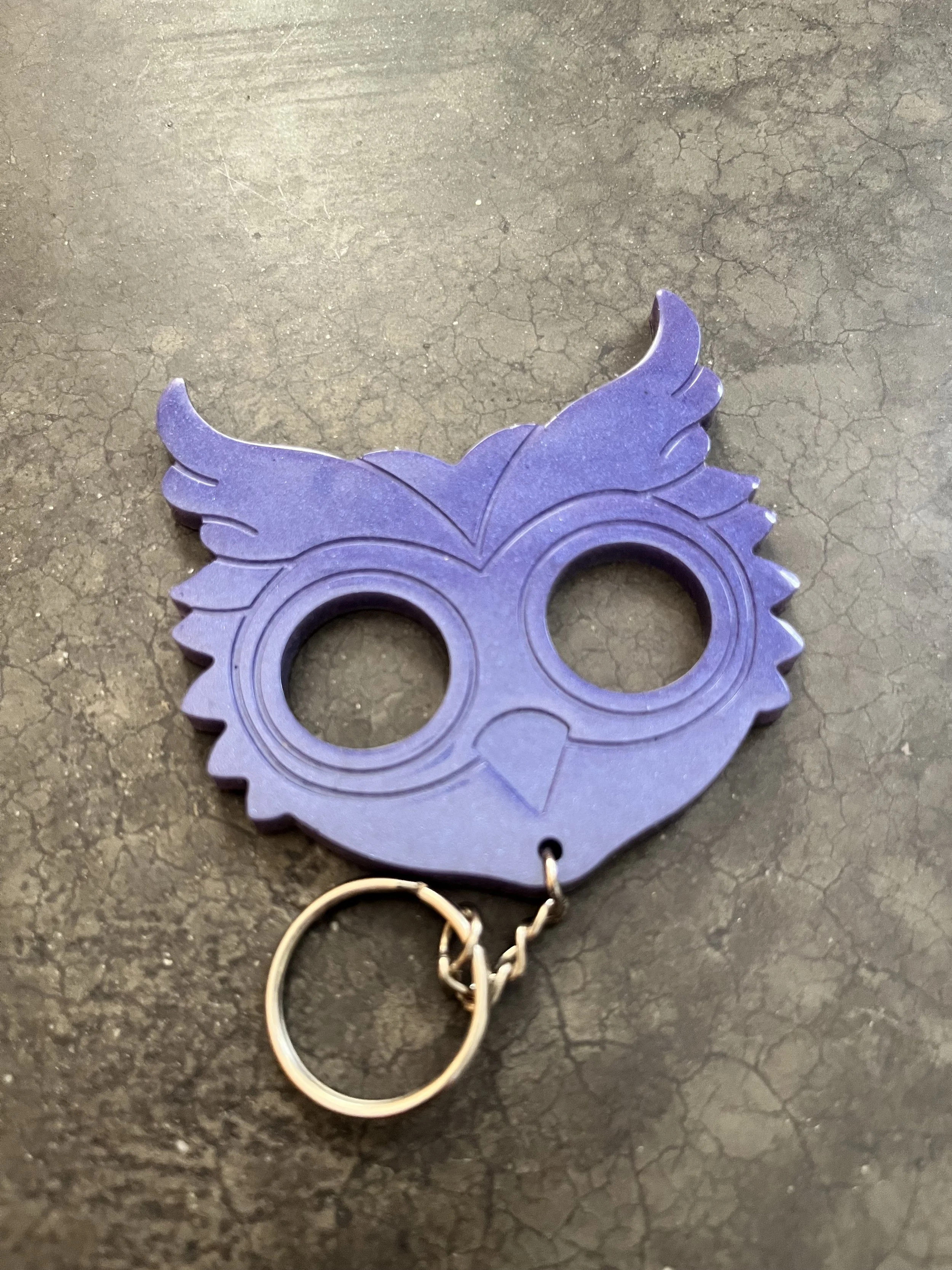 A handmade purple owl resin epoxy emergency keychain.
