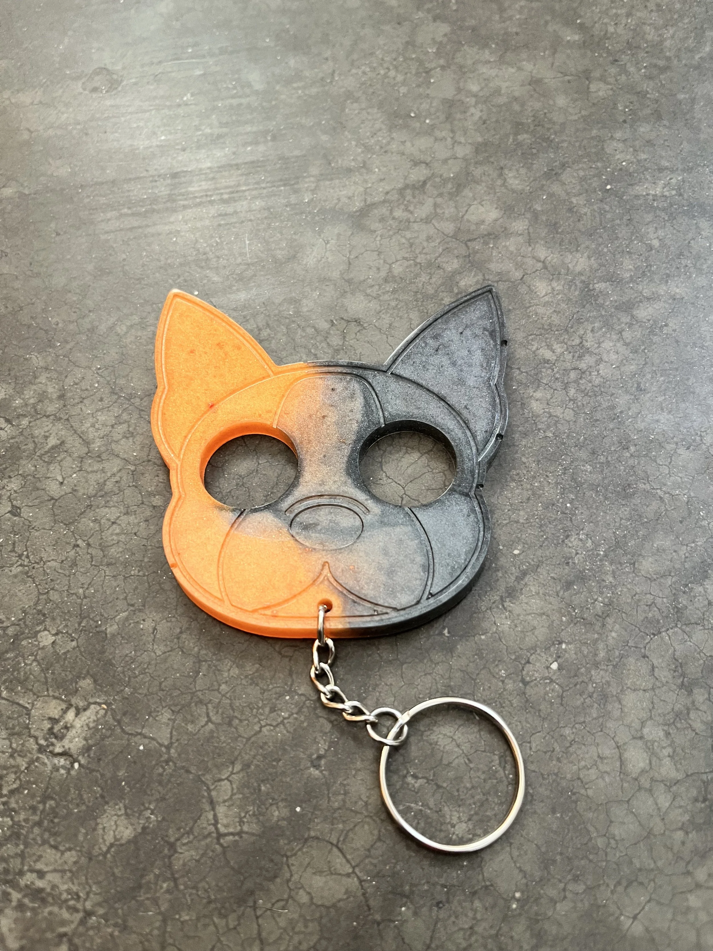 A handmade resin epoxy emergency keychain.