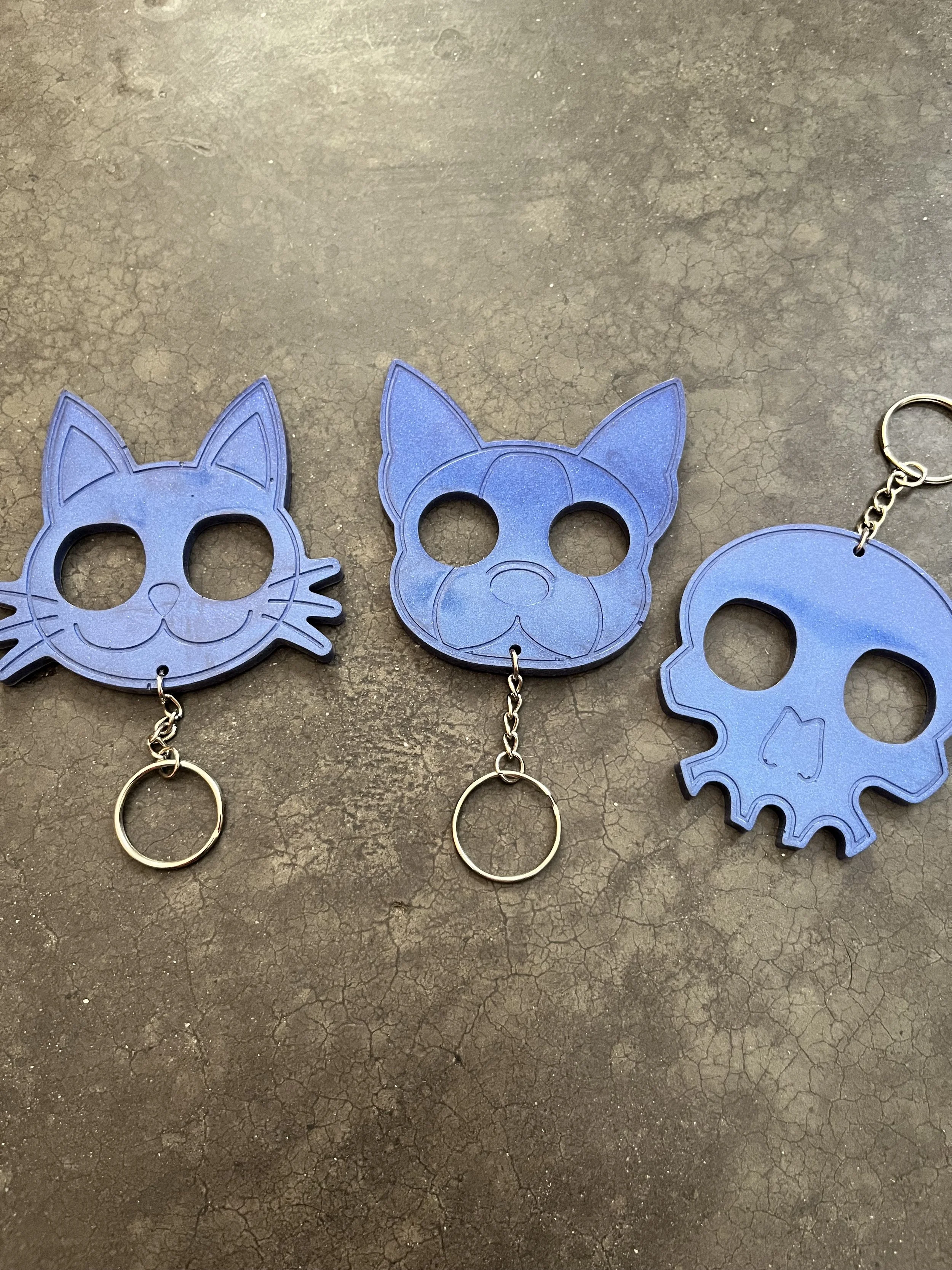 Three handmade blue resin epoxy emergency keychains.
