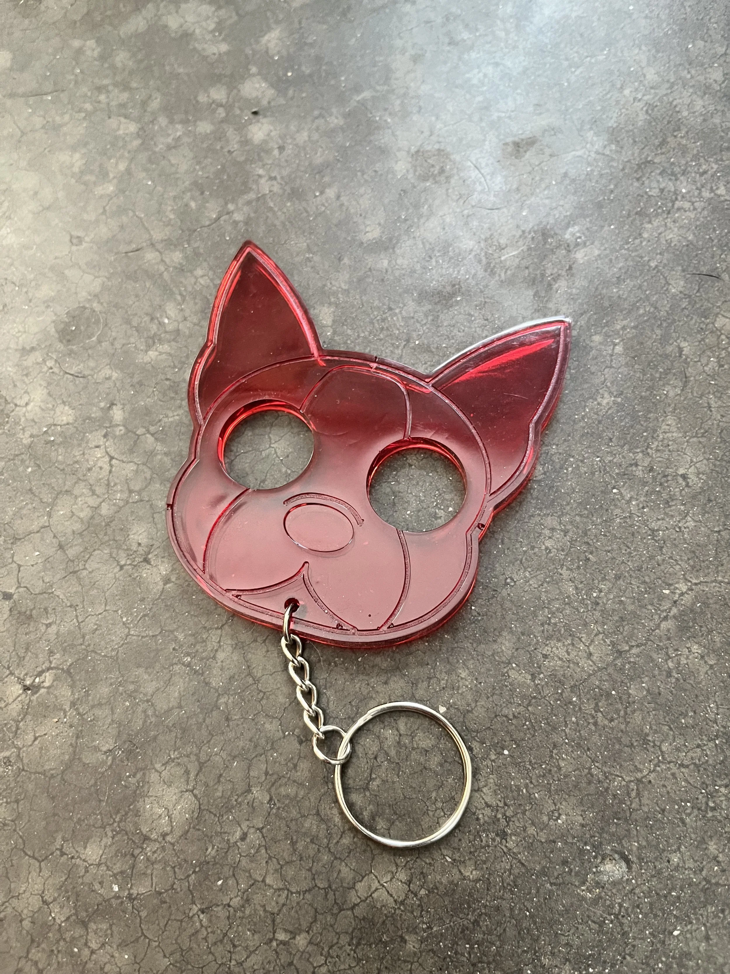 A dog face emergency keychain made from epoxy resin.