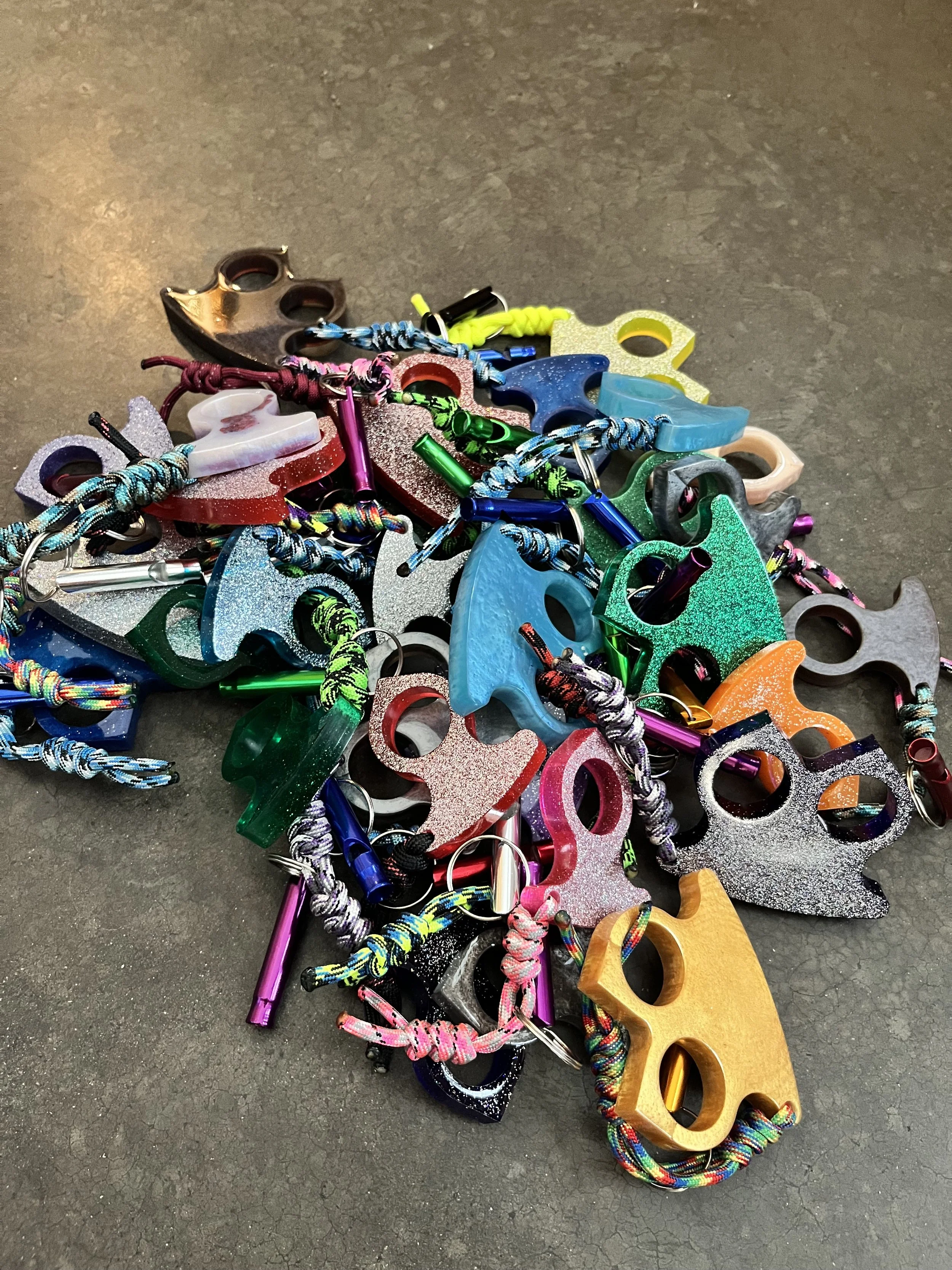A Pile of colorful resin epoxy emergency keychains.Totally legal.