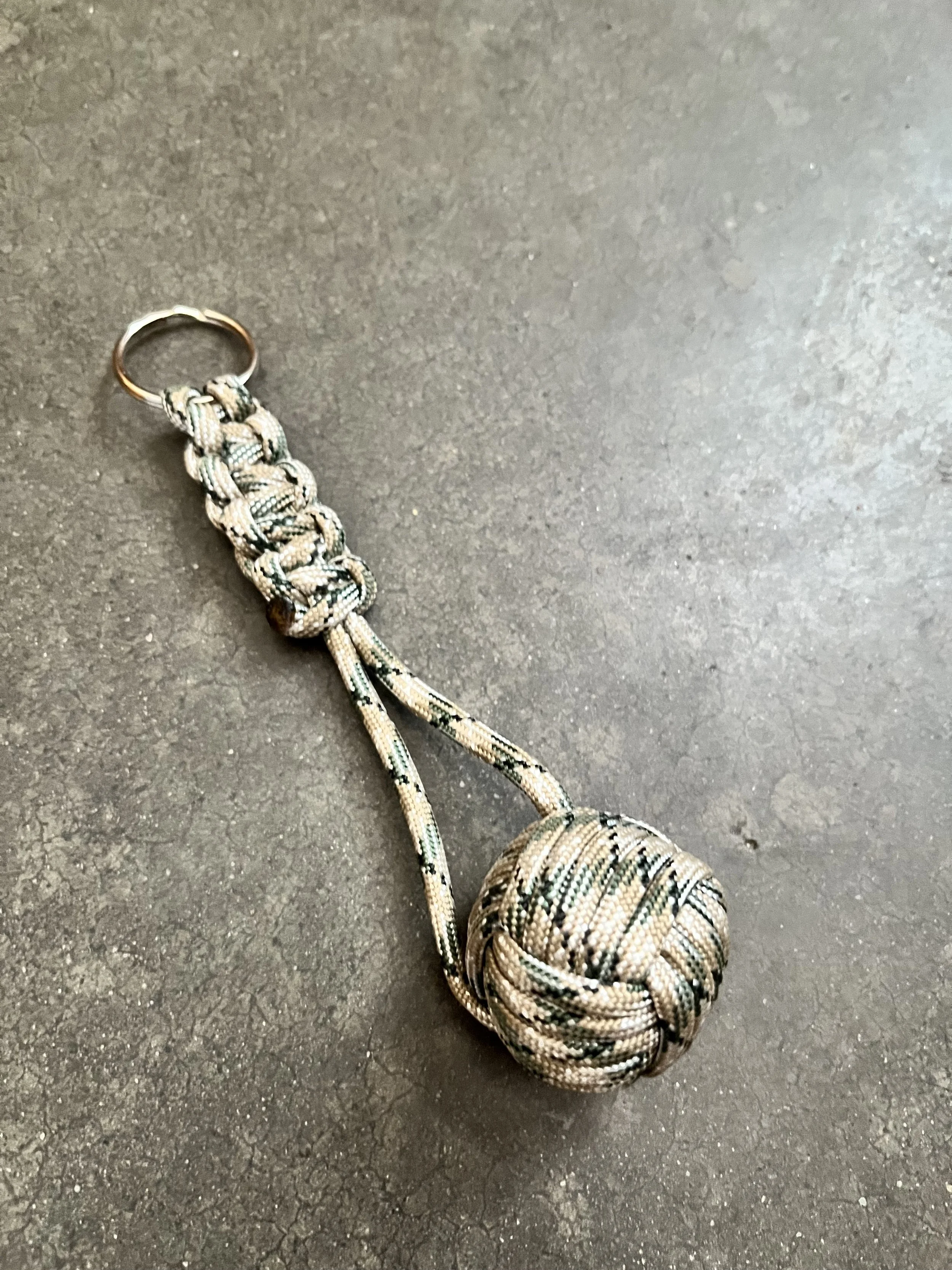 A handmade paracord monkey ball emergency keychain.