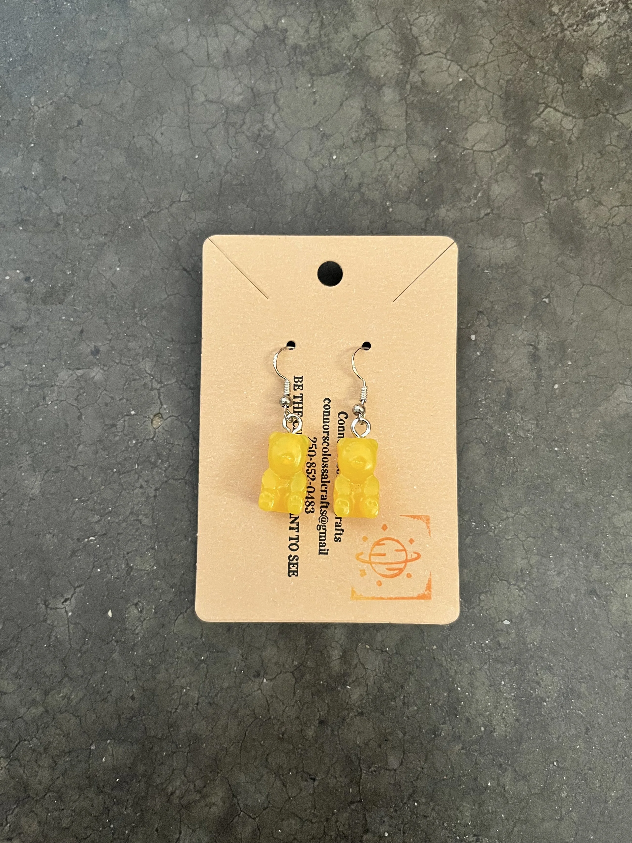 Handmade yellow resin epoxy gummy bear earrings.