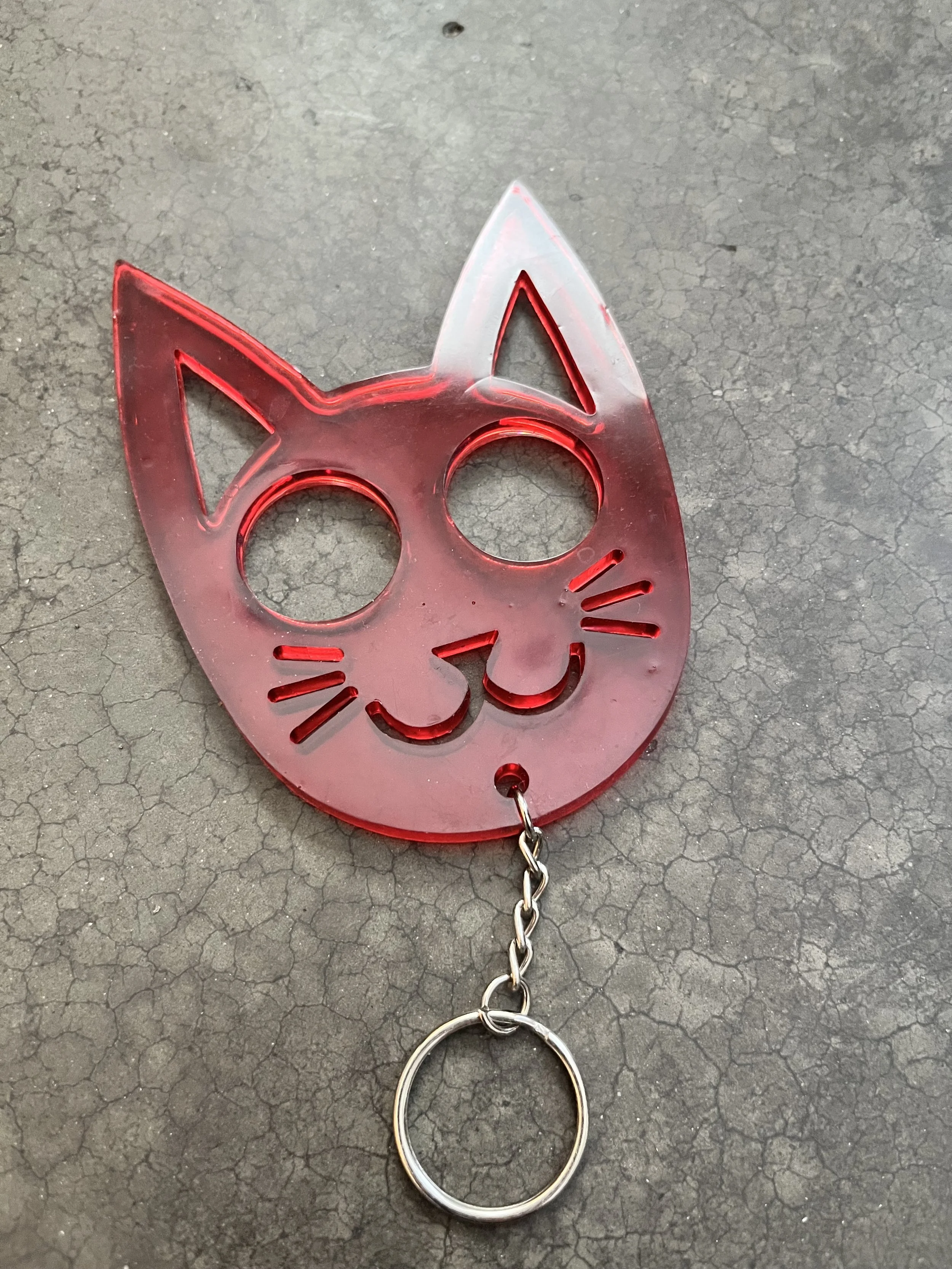 A handmade red cat resin epoxy emergency keychain.