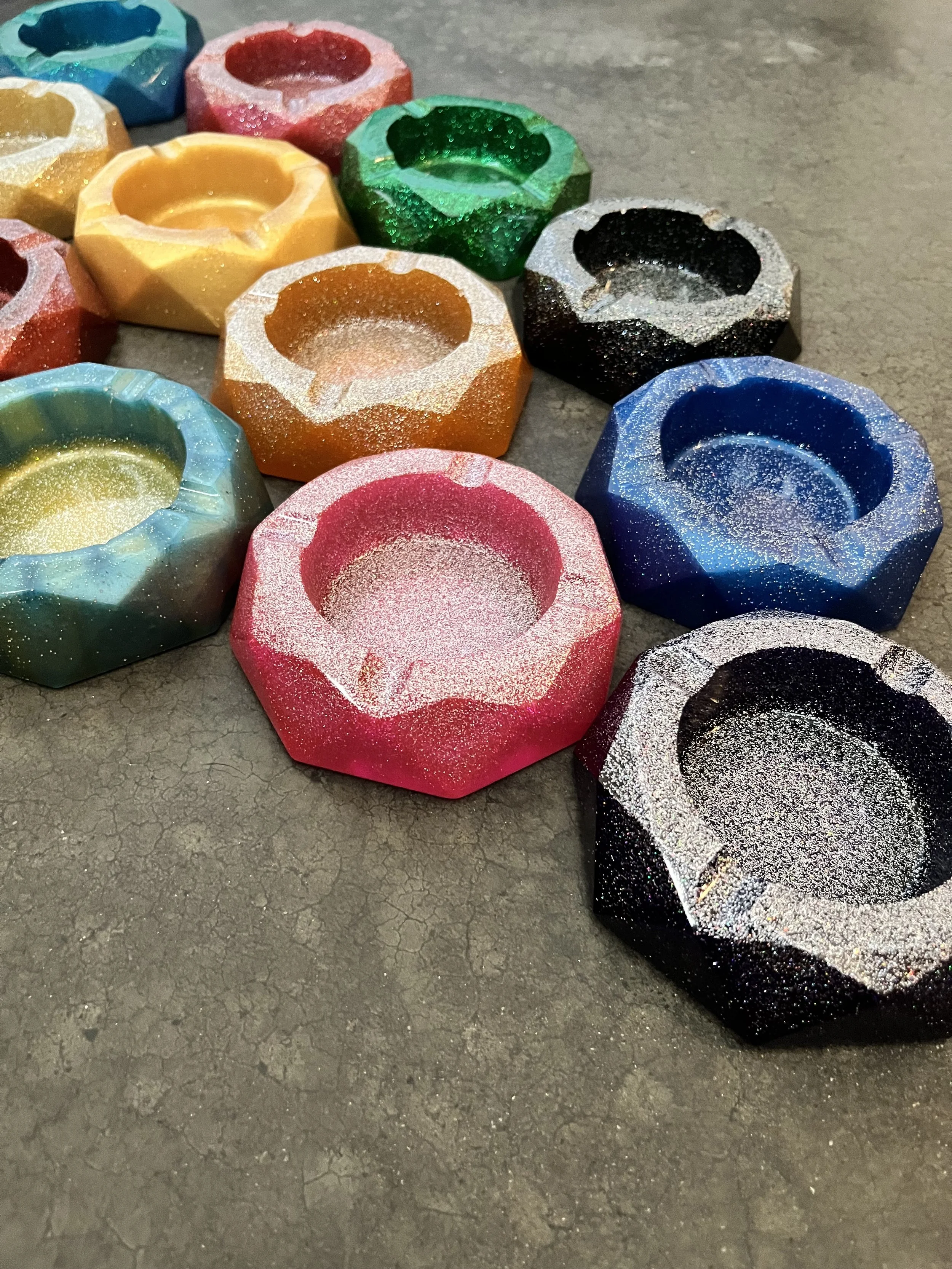 Handmade colorful, glittery, octagonal-shaped ashtrays/bowls.