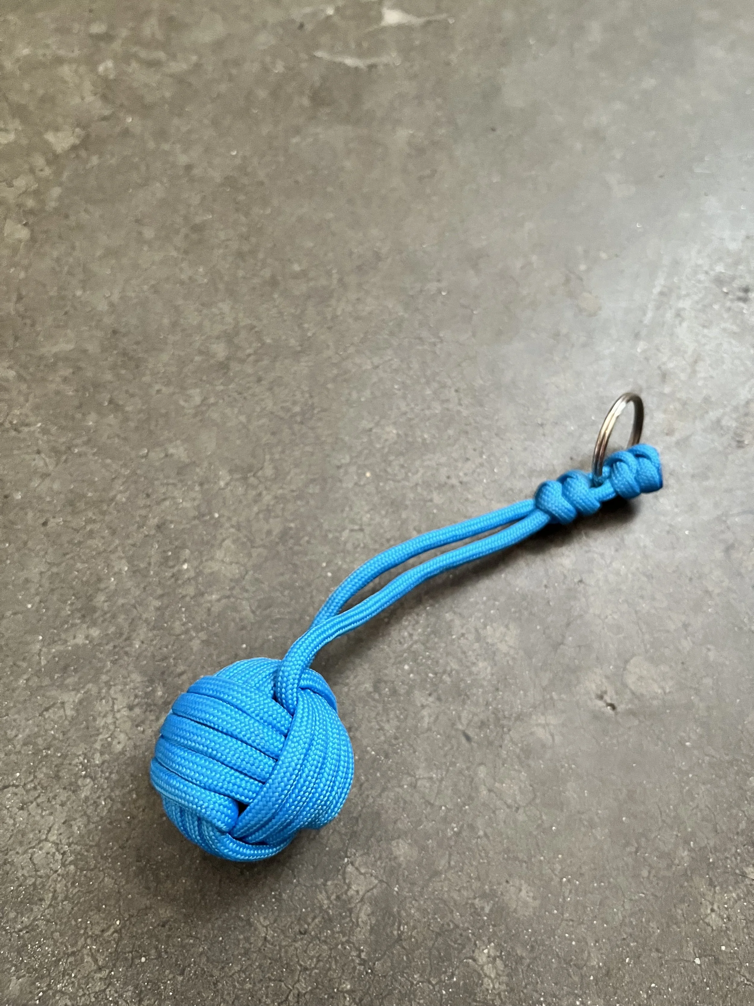 Handmade blue paracord monkey ball keychain.