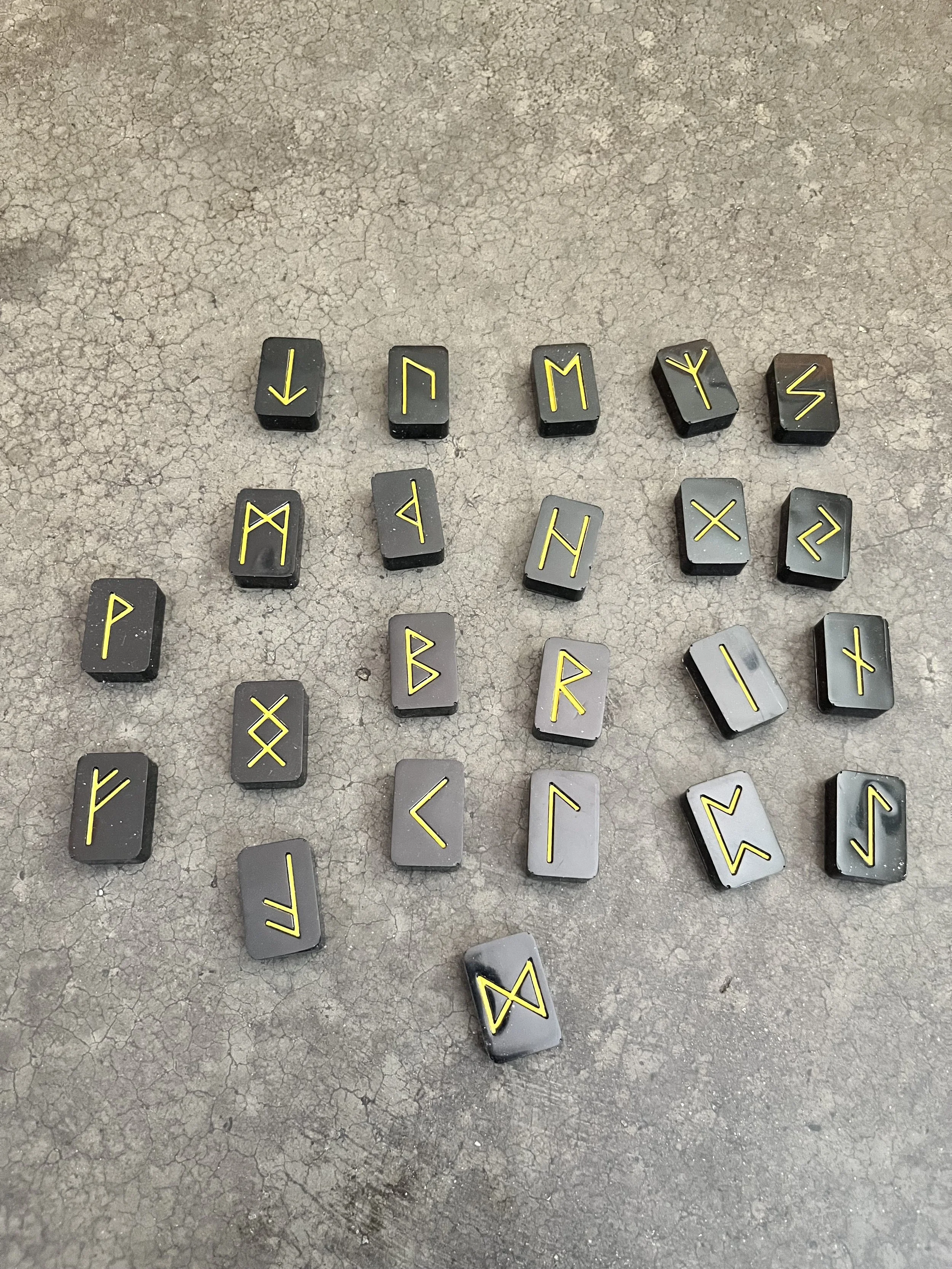 Handmade black and gold resin epoxy rune stones.