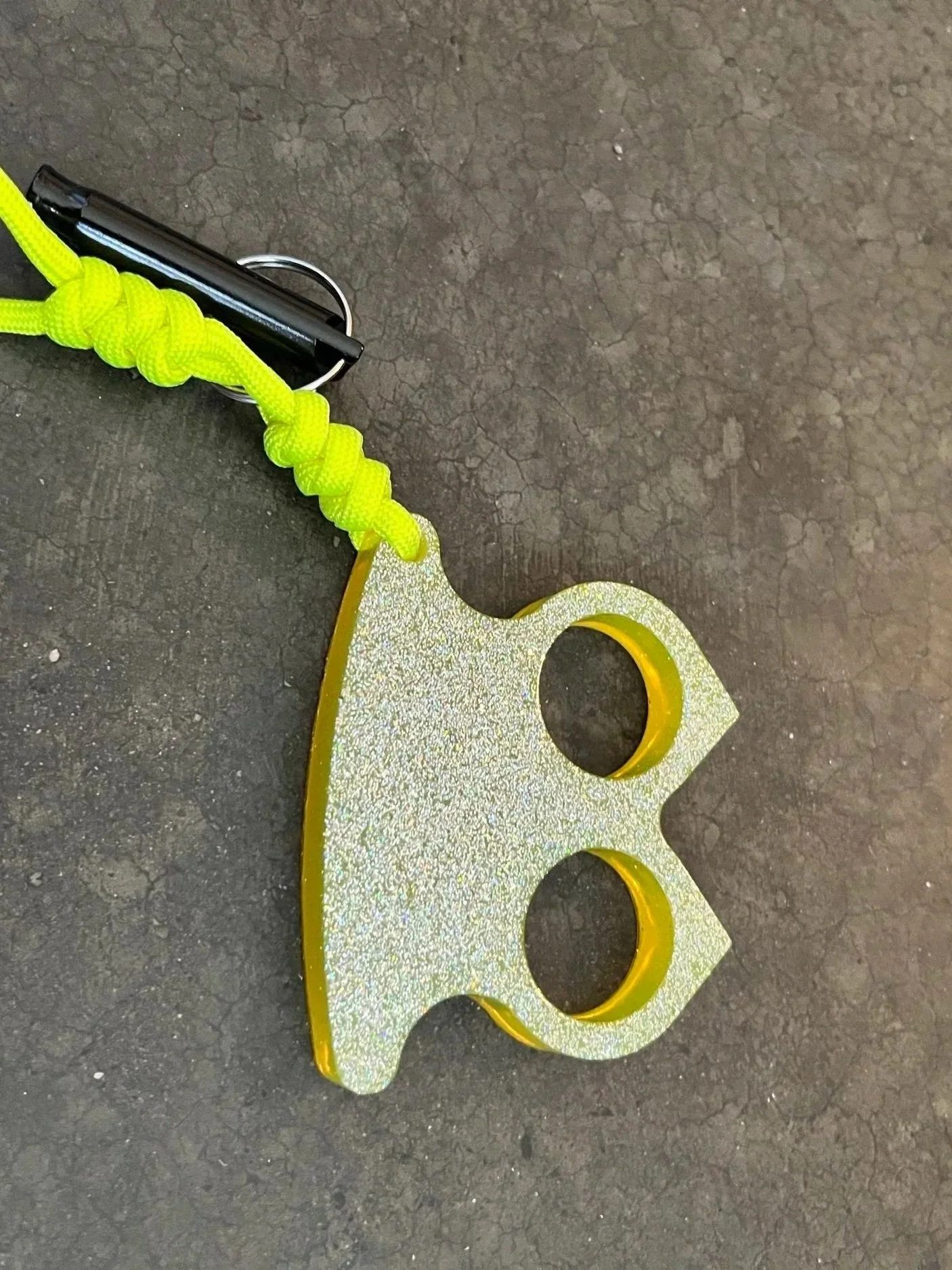 Yellow epoxy resin knuckle keychain with paracord.