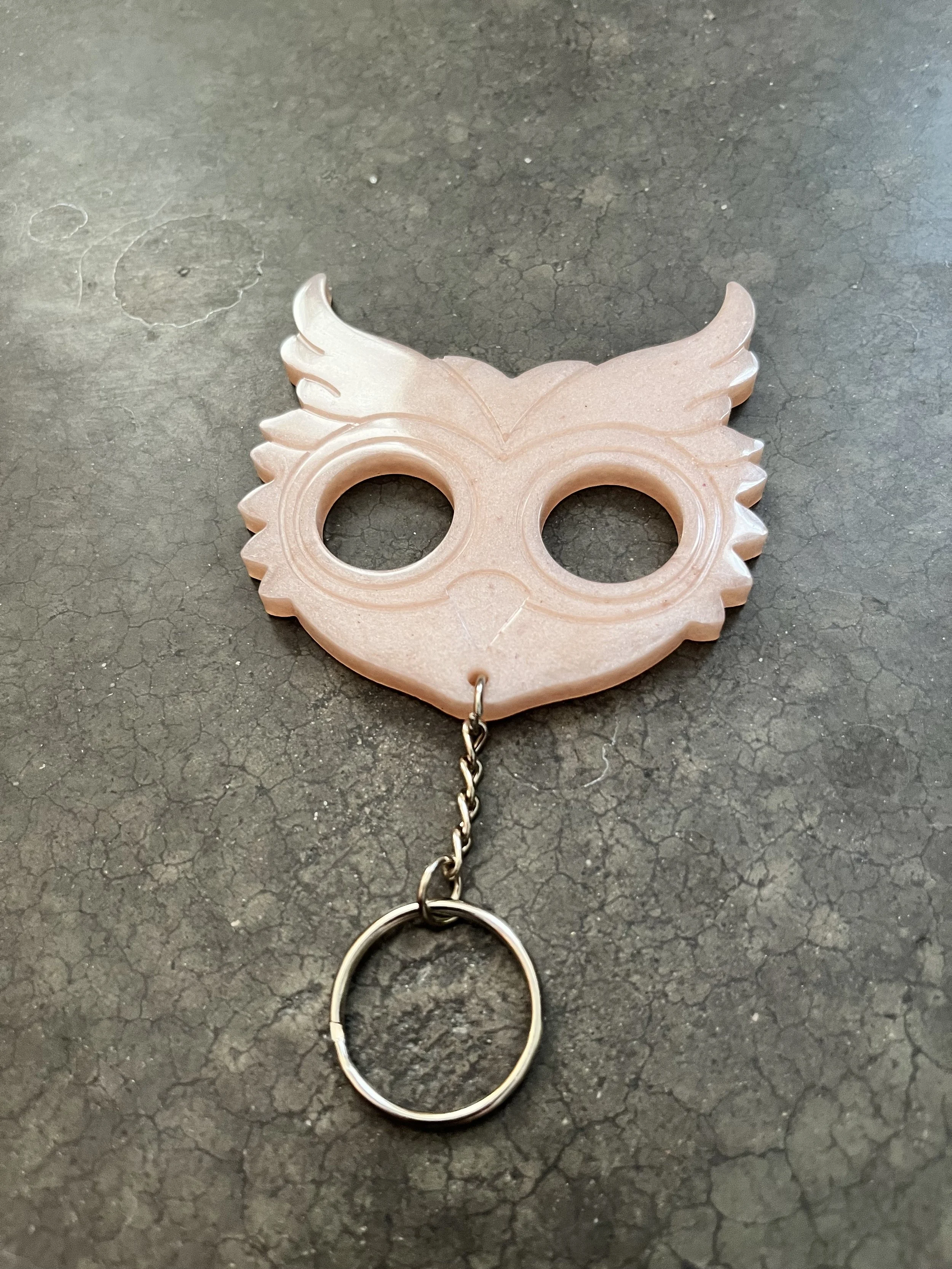 A pink owl-shaped emergency keychain made from epoxy resin.