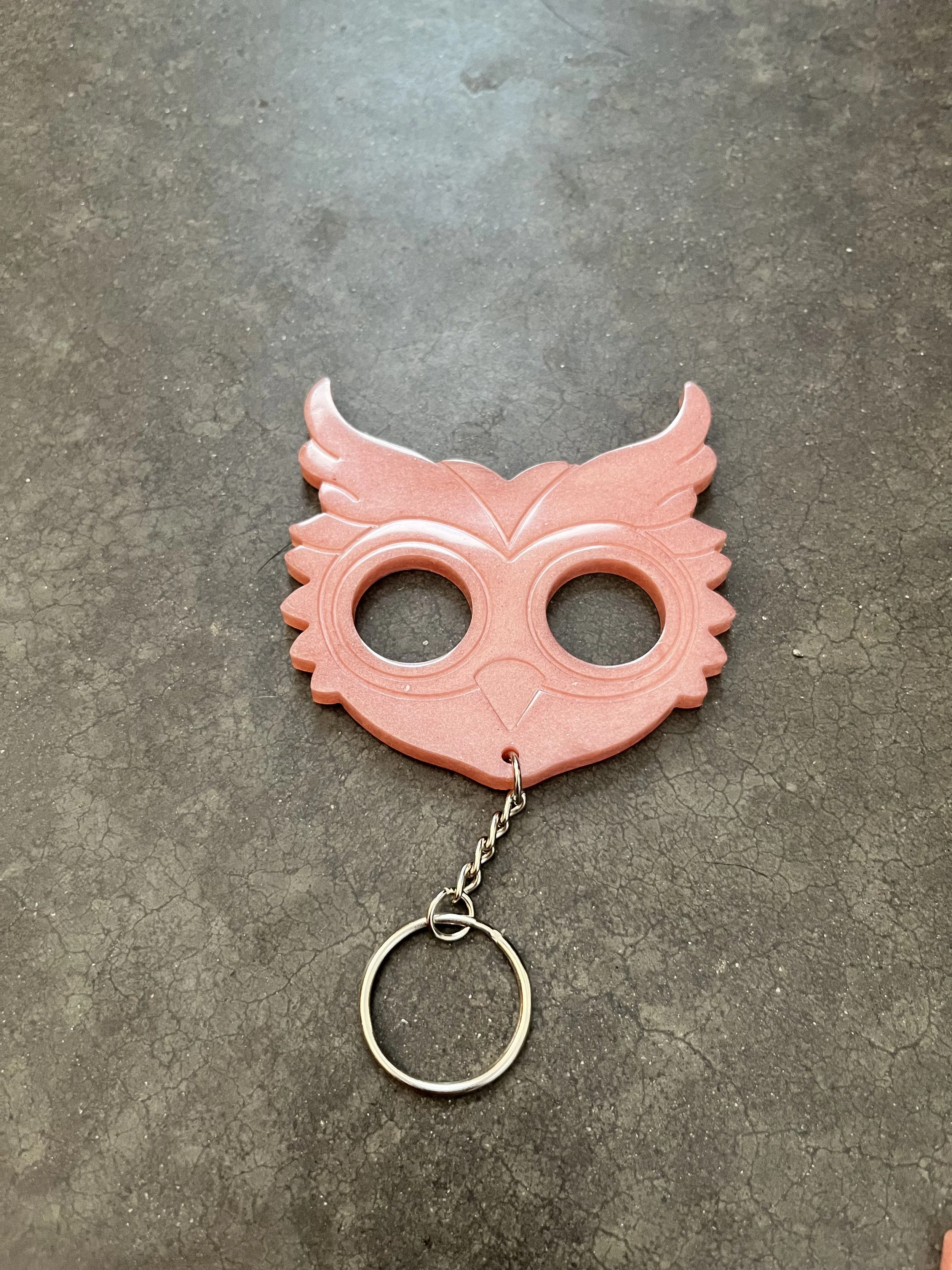 A handmade owl-shaped resin epoxy emergency keychain.