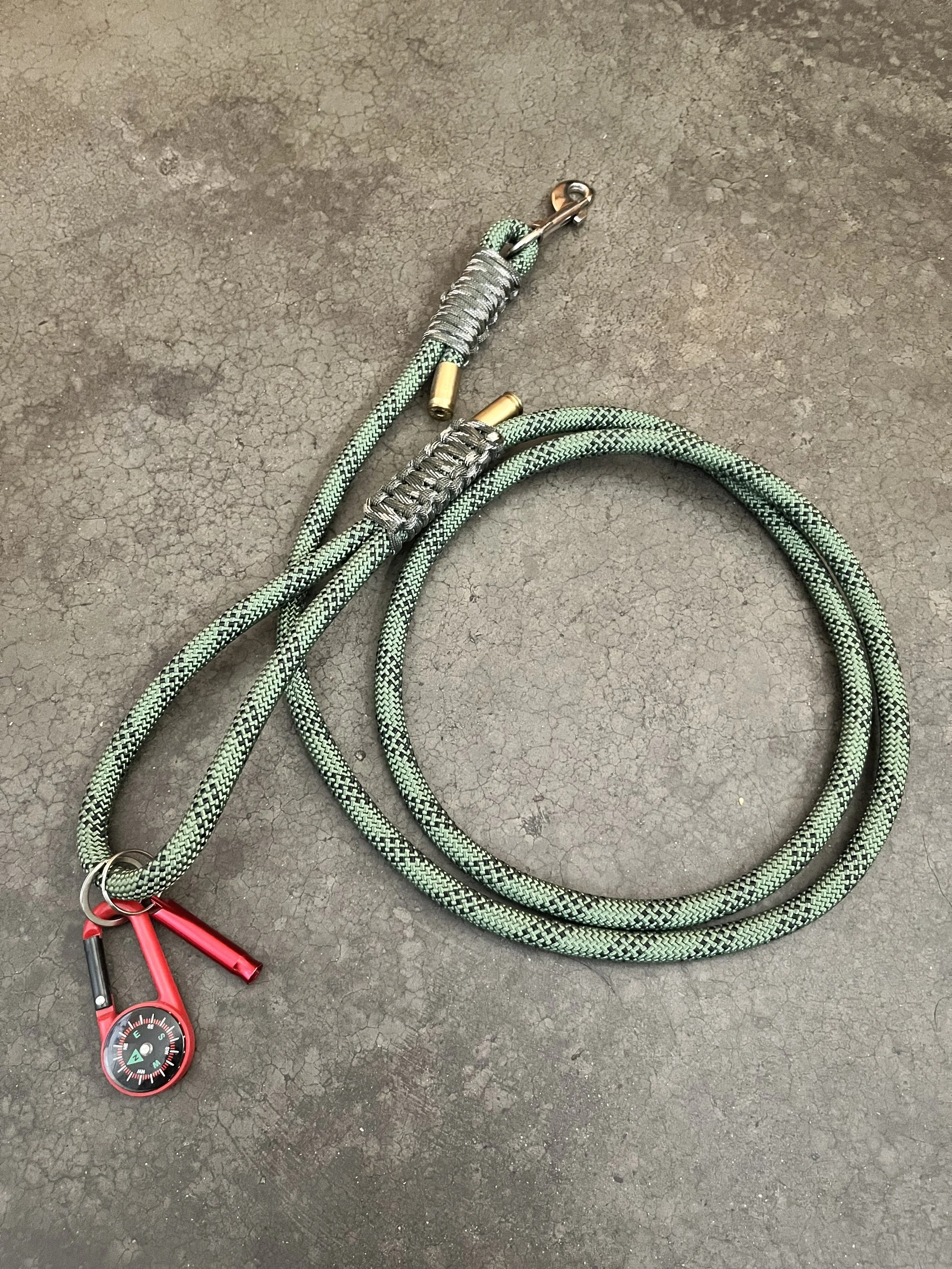 A green handmade dog leash with a red carabiner.
