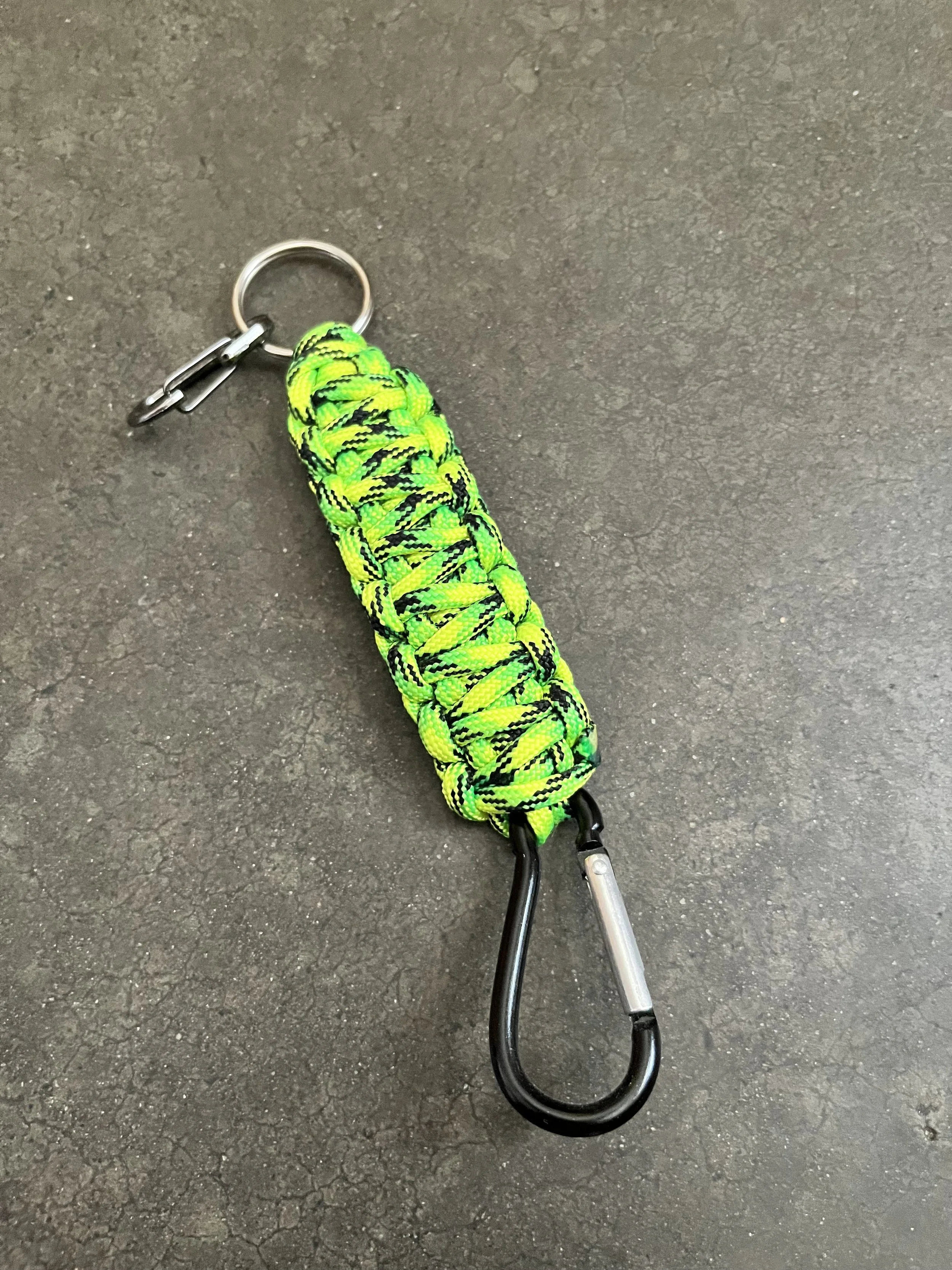 A handmade colorful paracord keychain with a carabiner.
