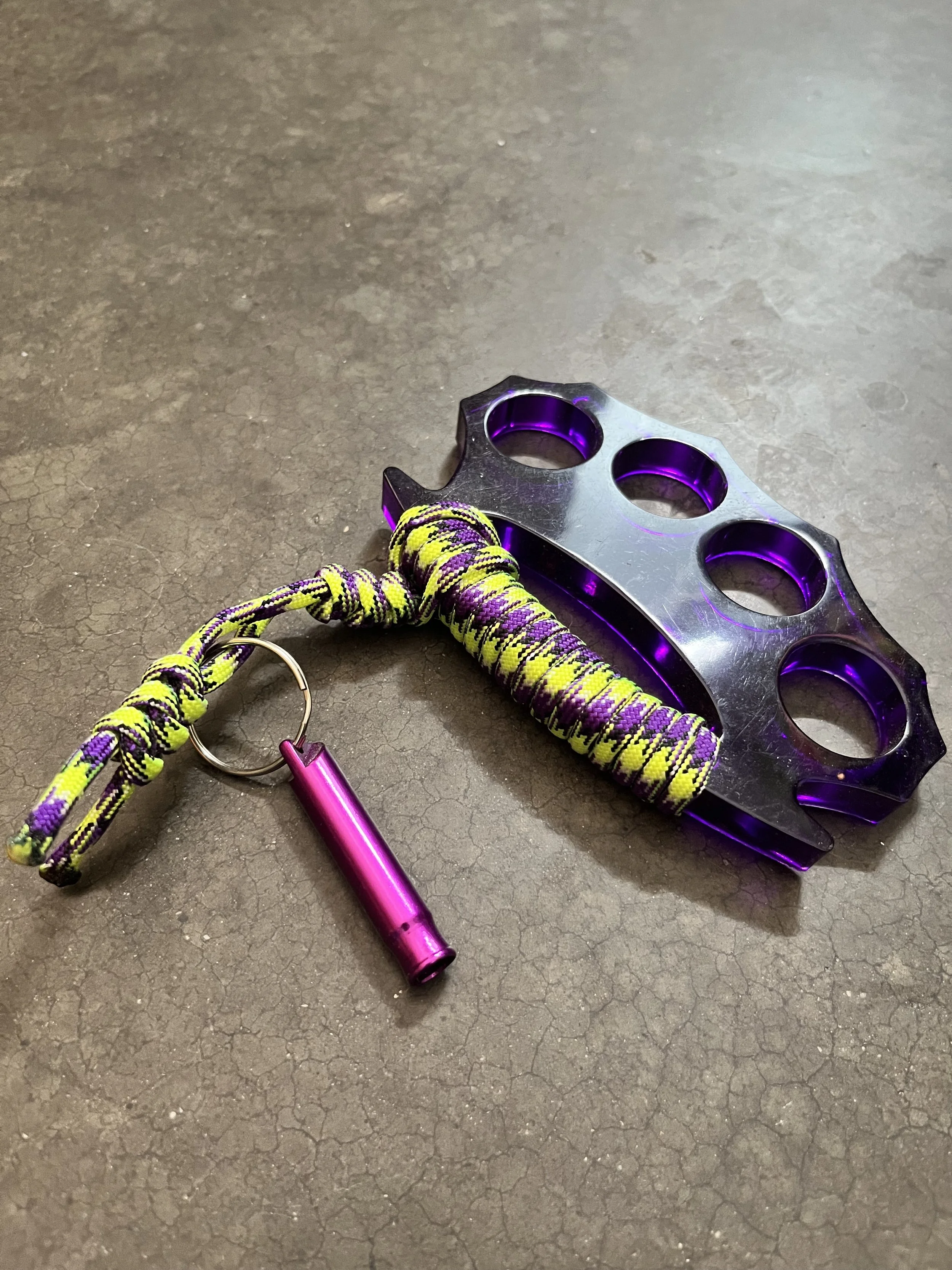 A purple emergency keychain made from epoxy resin.