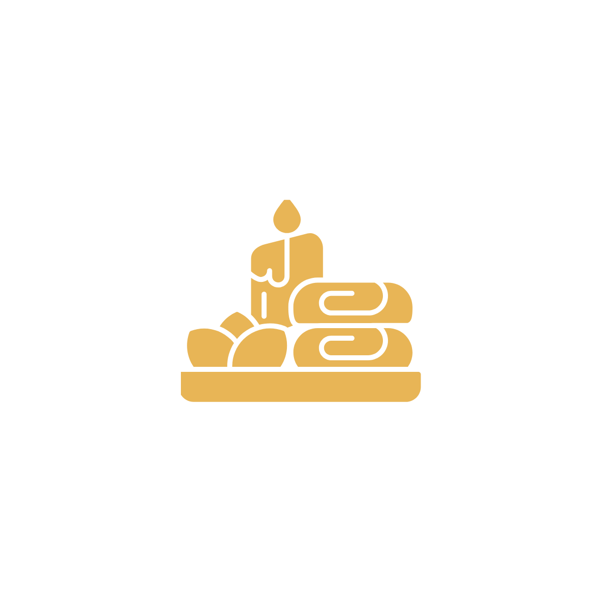 Gold-colored cluster of candles and rolled towels on black background
