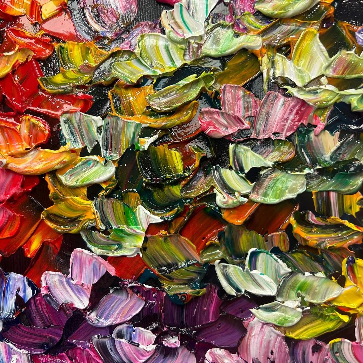 Close-up of an abstract acrylic painting with thick, colorful strokes in red, green, yellow, pink, purple, black, and white, creating a textured, swirling pattern.
