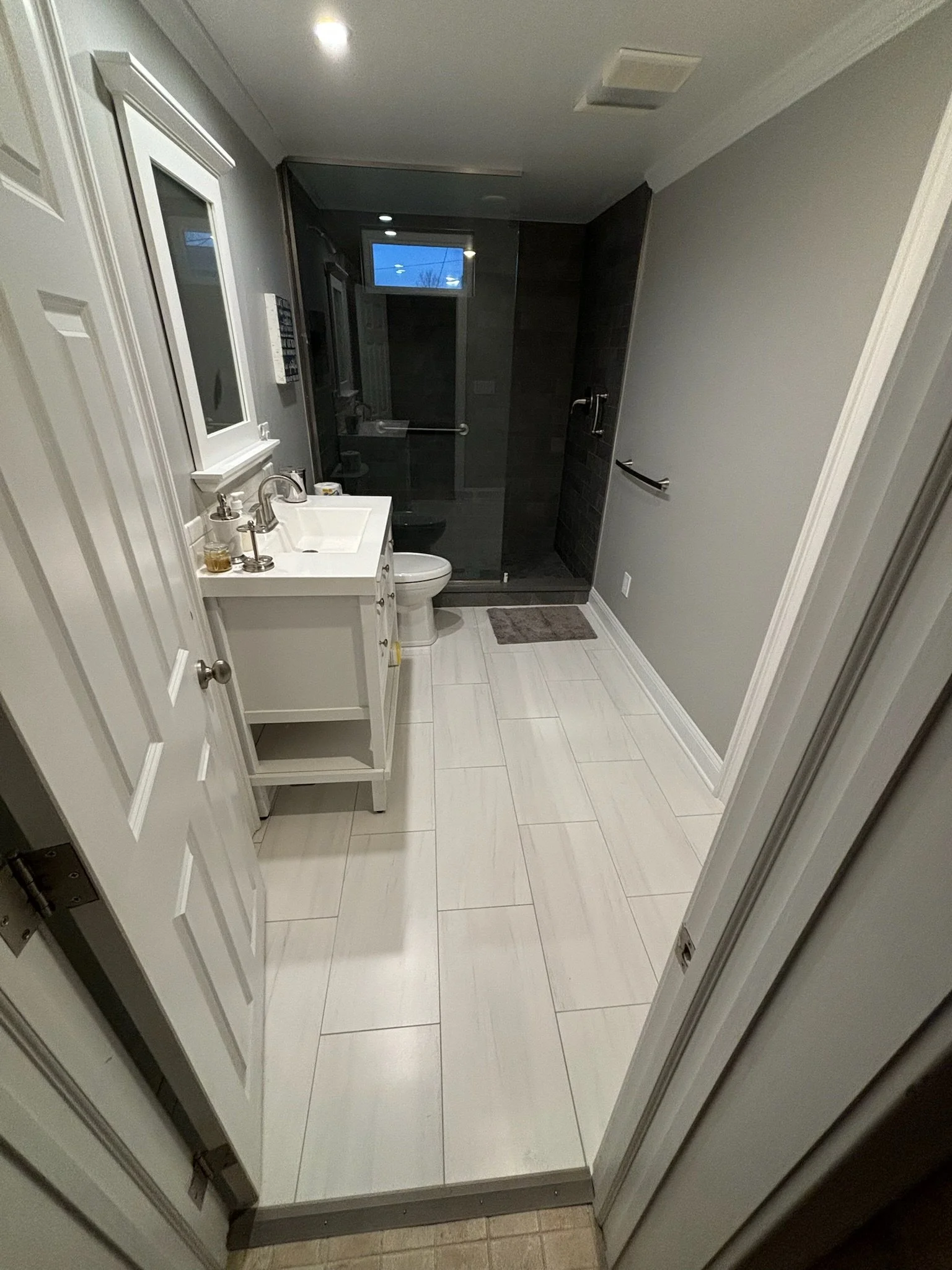bathroom remodel with stand-up shower, new sink and vanity, and flooring