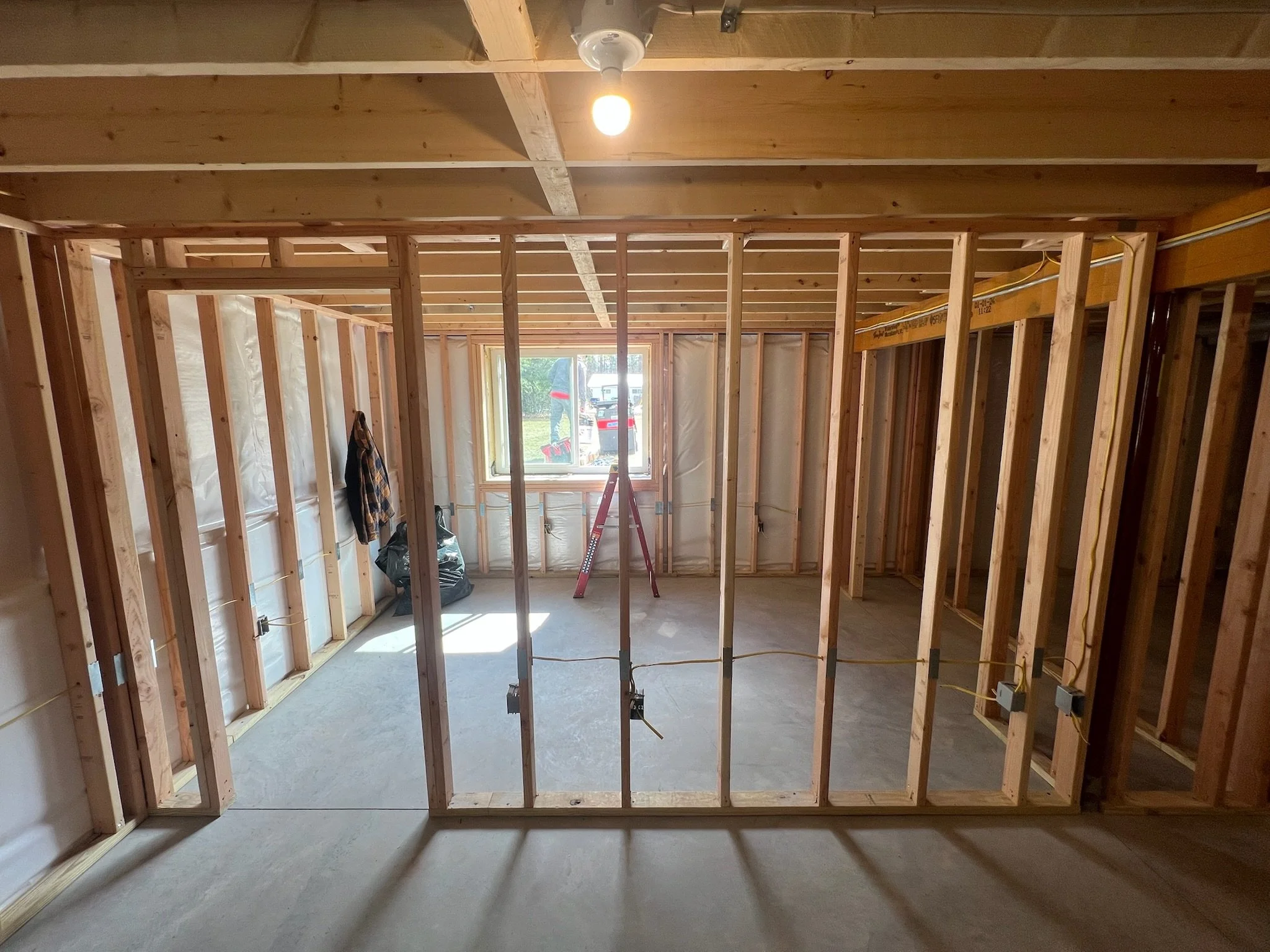 studs are set up to designate rooms and space for a basement remodel project