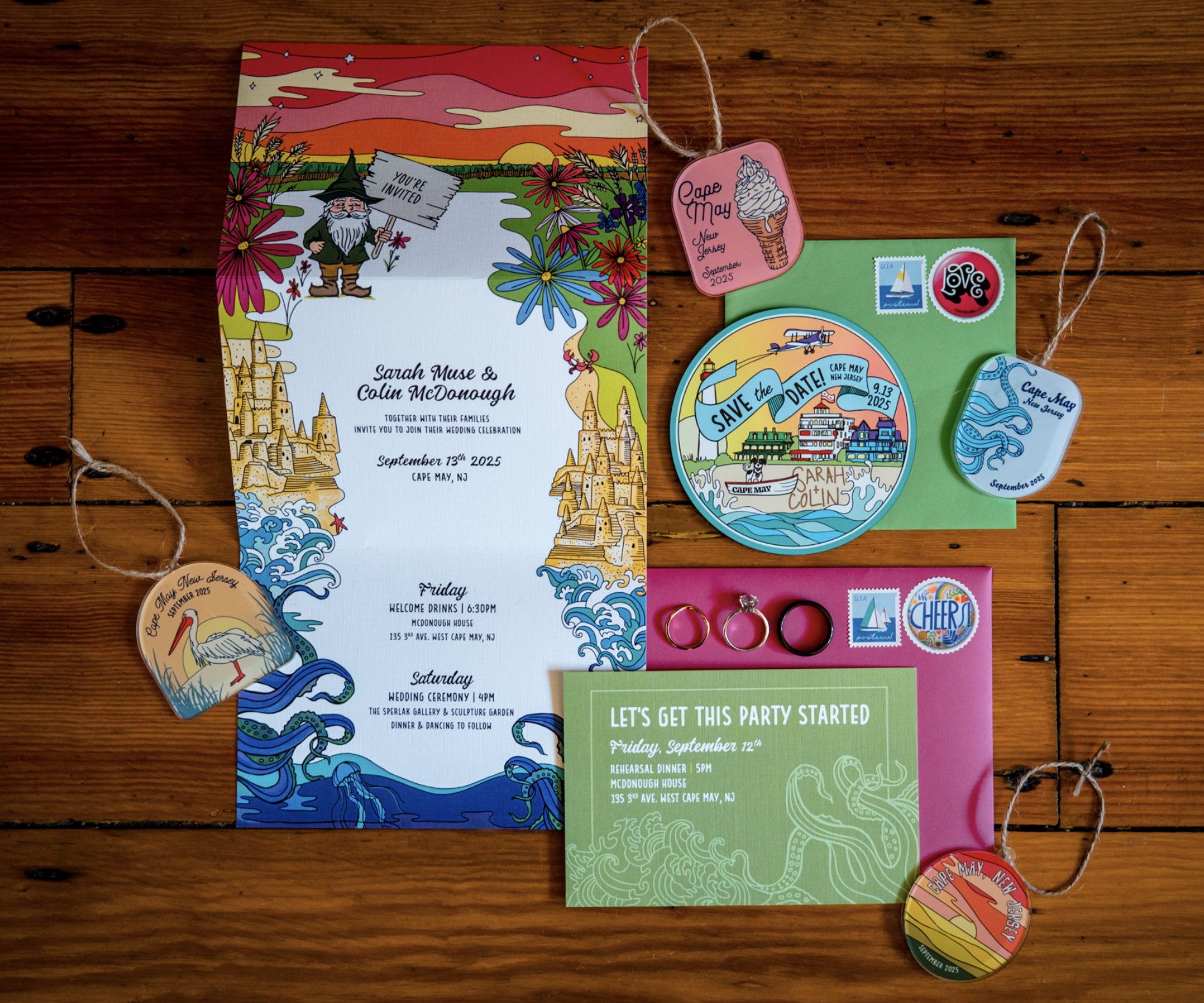 Colorful wedding invitation and event cards for a wedding in Cape May, New Jersey, with stamps, tags, and decorative elements on a wooden surface.