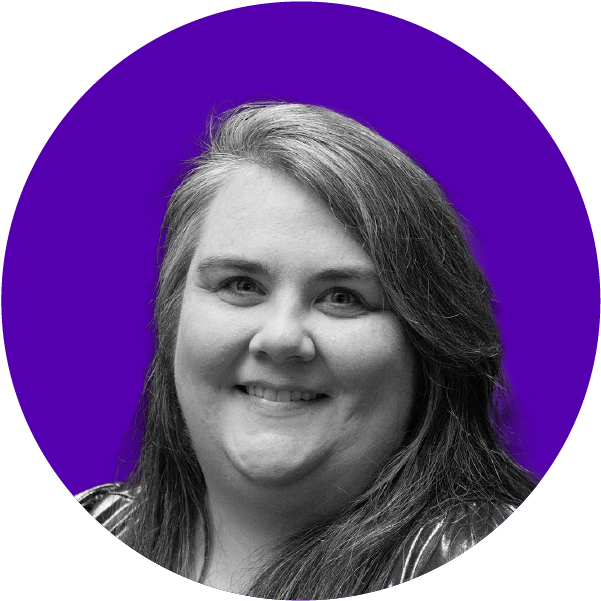 Black and white portrait of a smiling woman with long hair, set against a purple background.