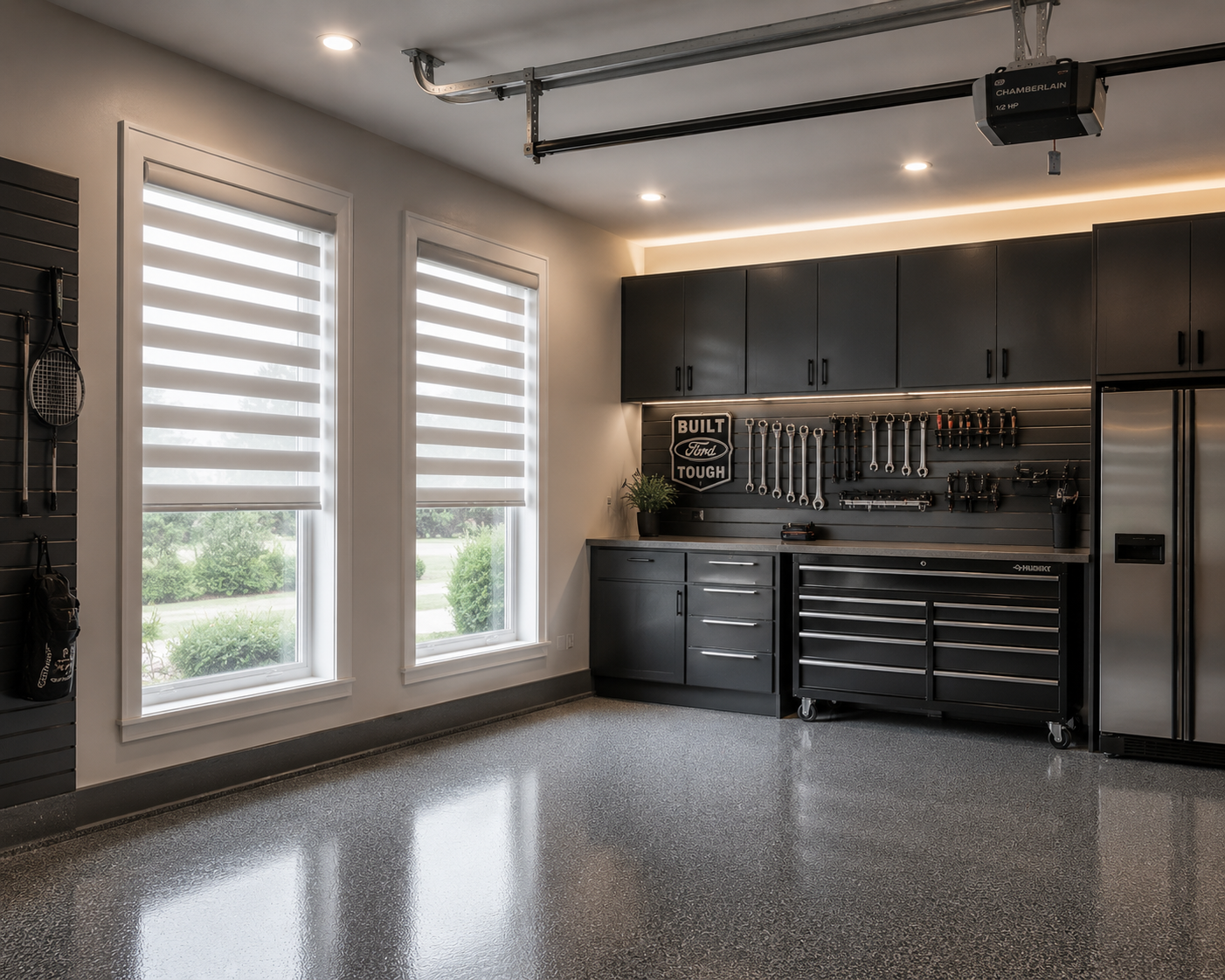 Garage with two large windows, black tool cabinets, and a pegboard wall with tools.